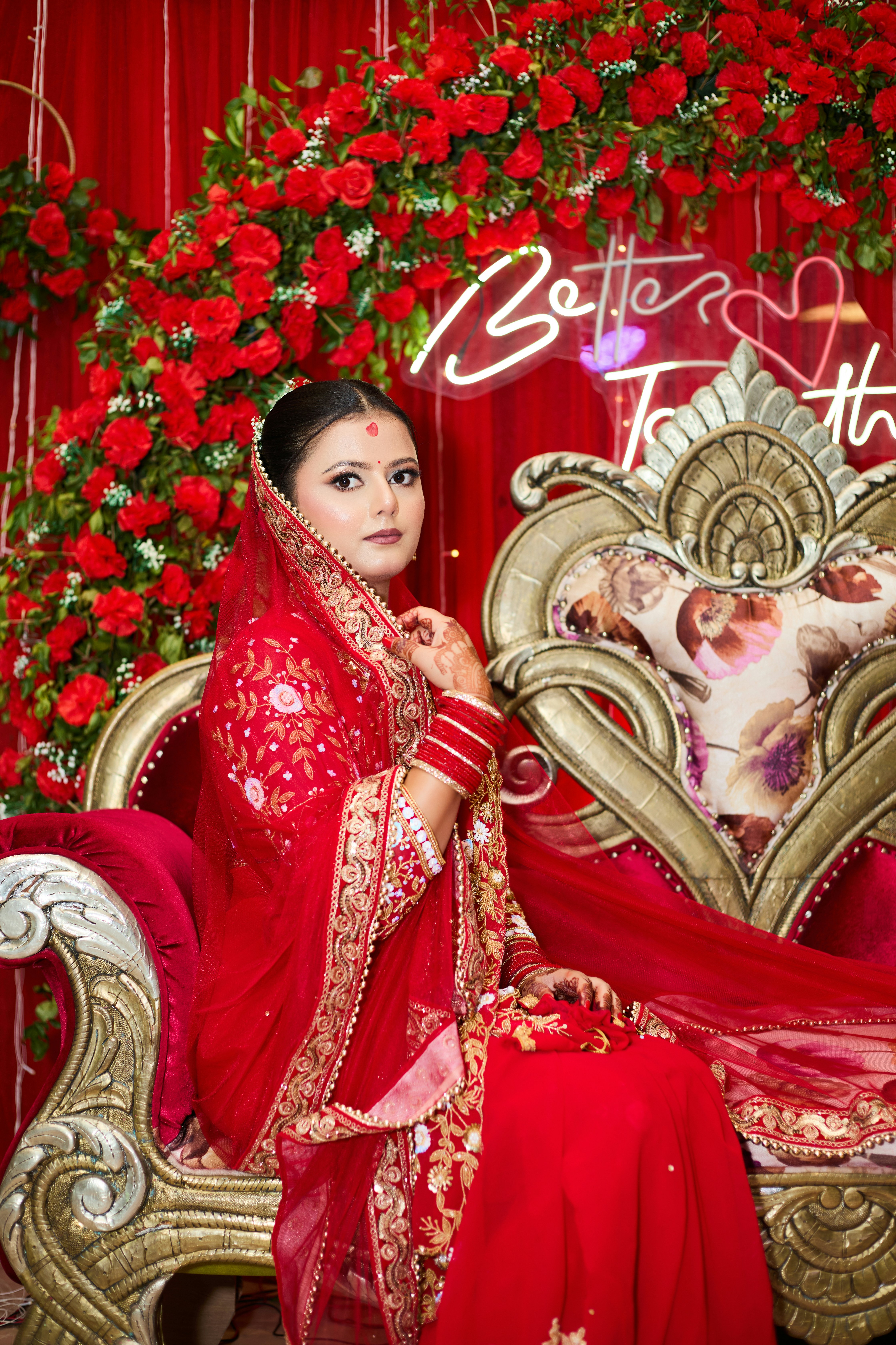 A woman in a red dress sitting on a couch