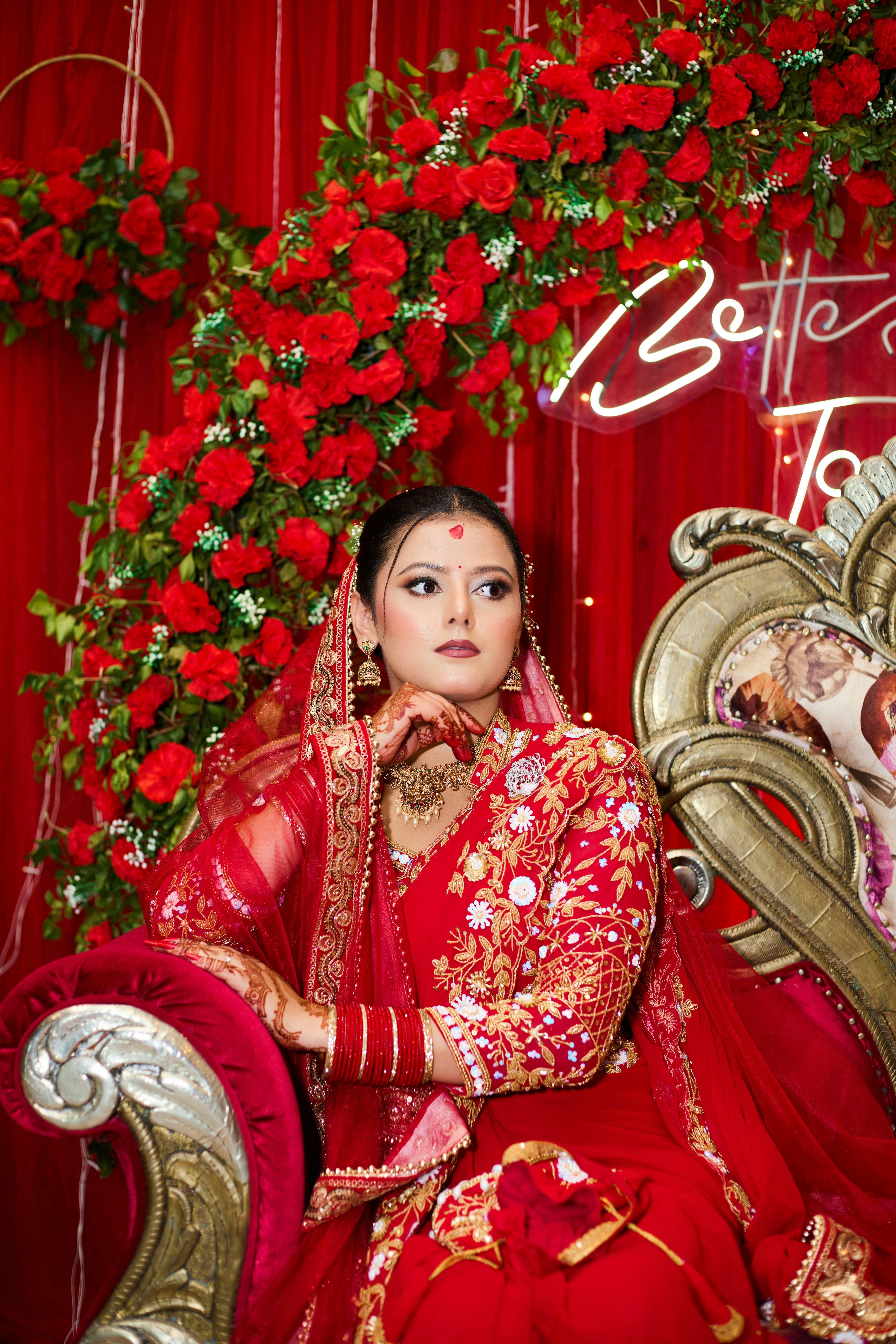 A woman in a red dress sitting on a chair