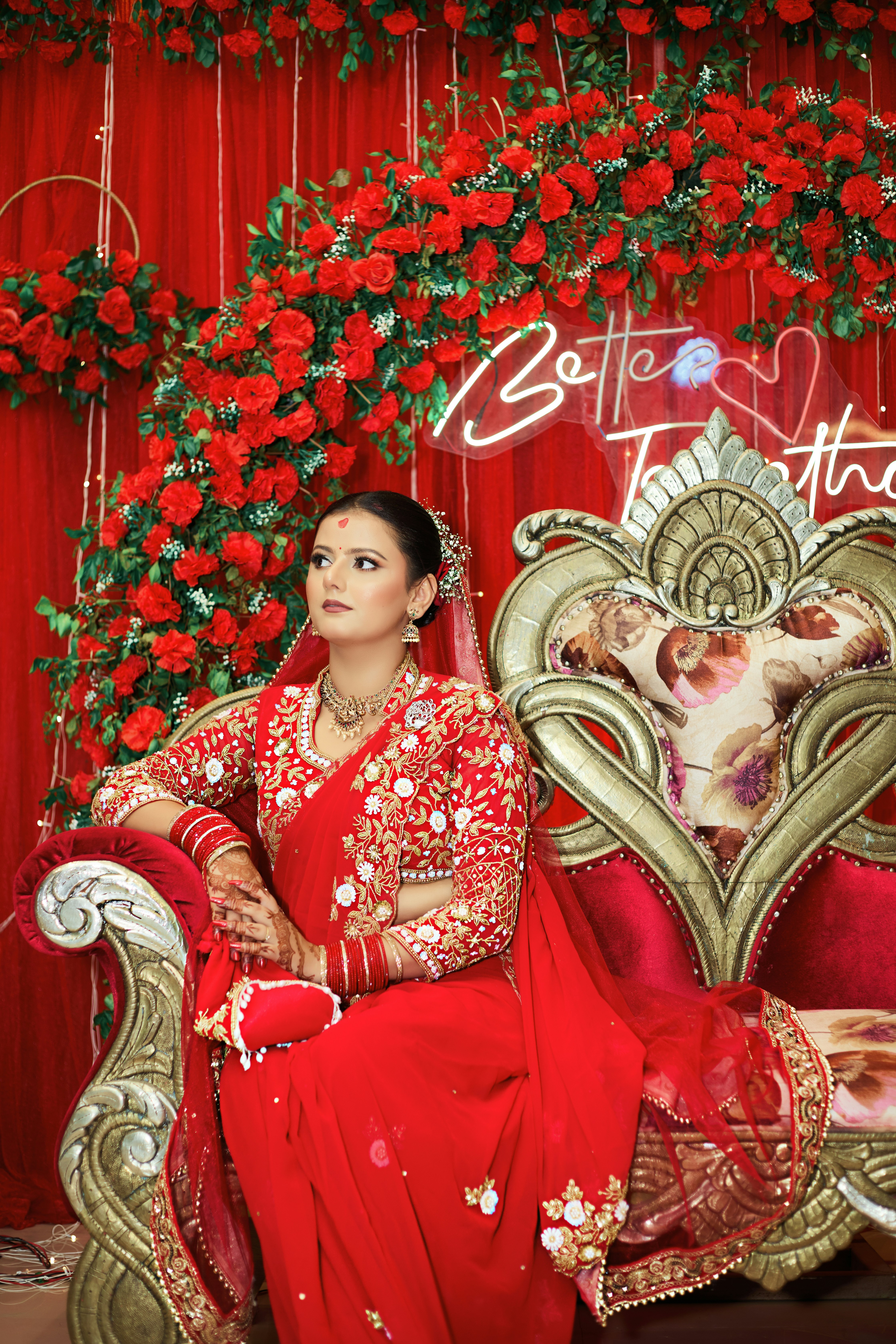 A woman in a red dress sitting on a couch