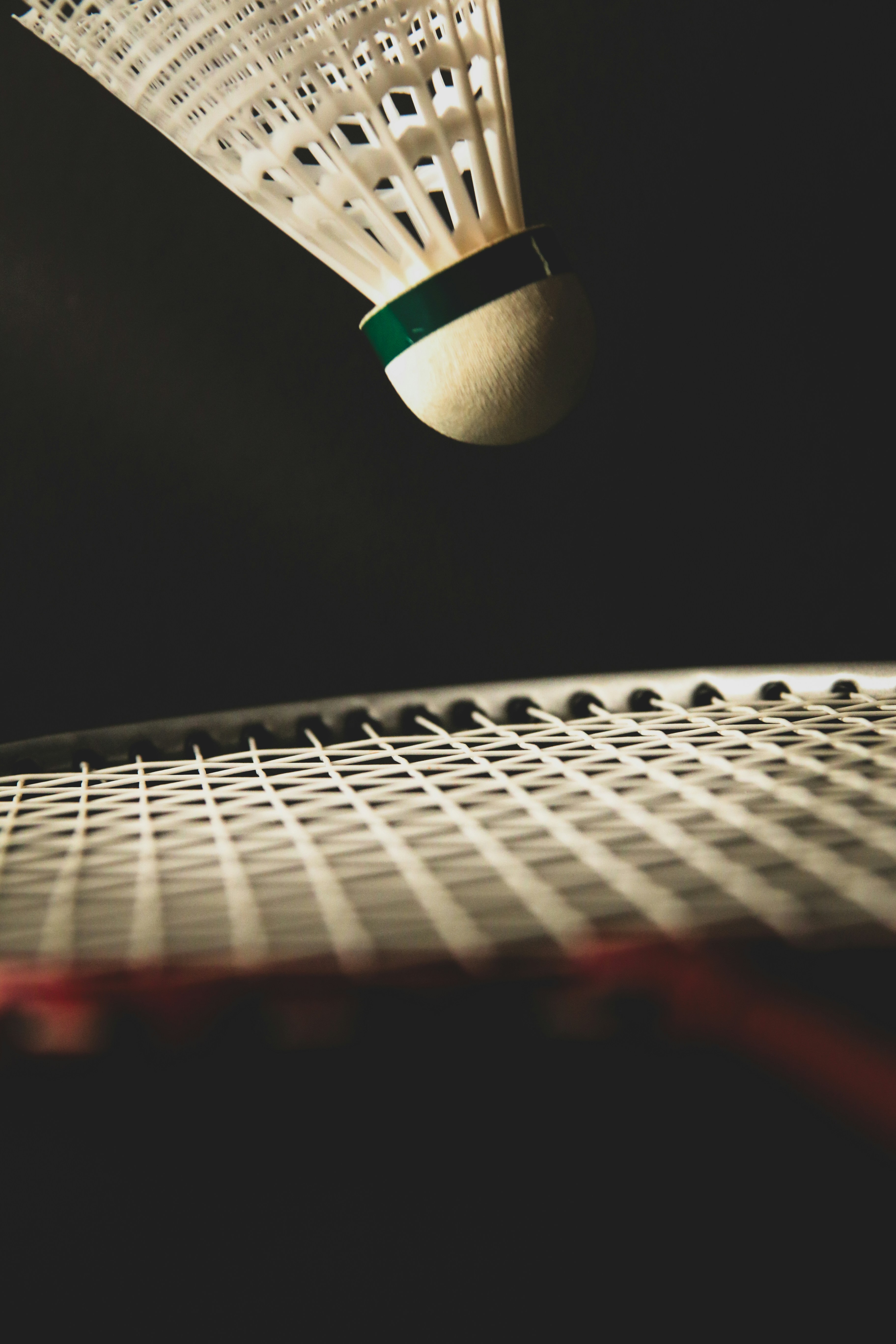 A close up of a tennis racket and a ball