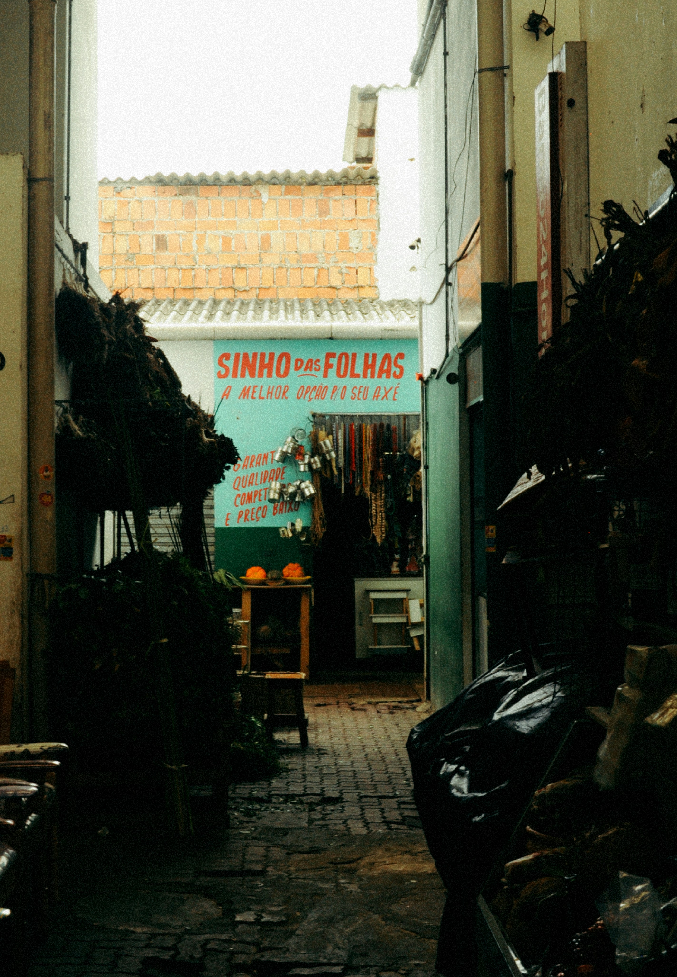 A narrow alley way with lots of items on display