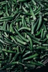 A pile of green beans sitting on top of a table