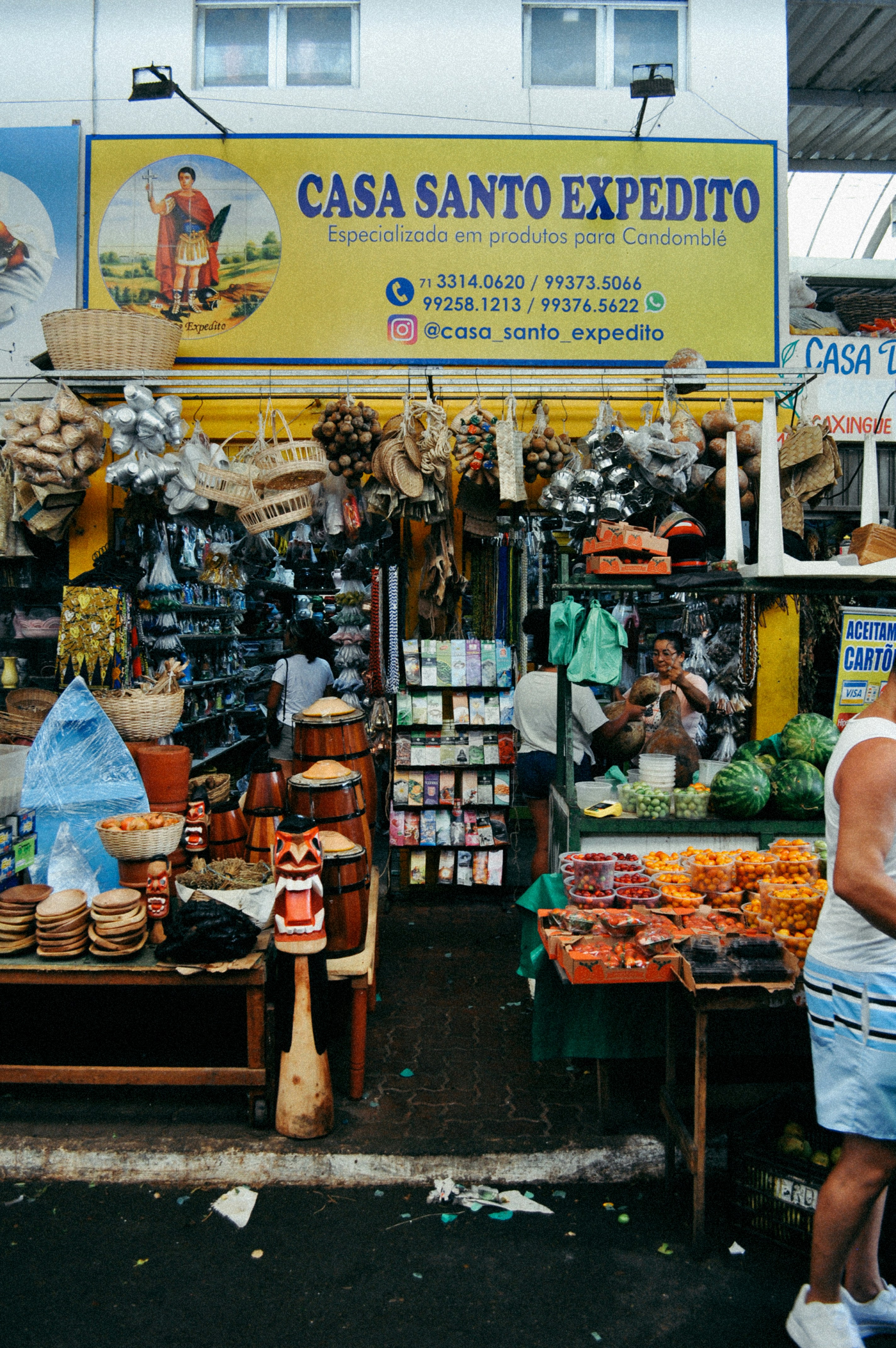 A woman is standing in front of a market