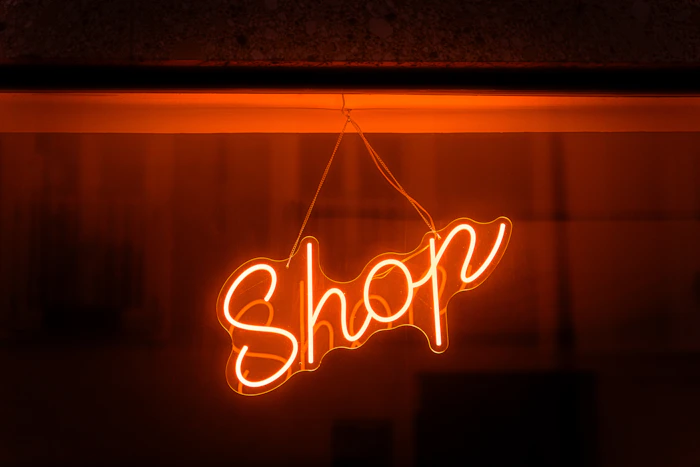 Illuminated neon shop sign glowing at night