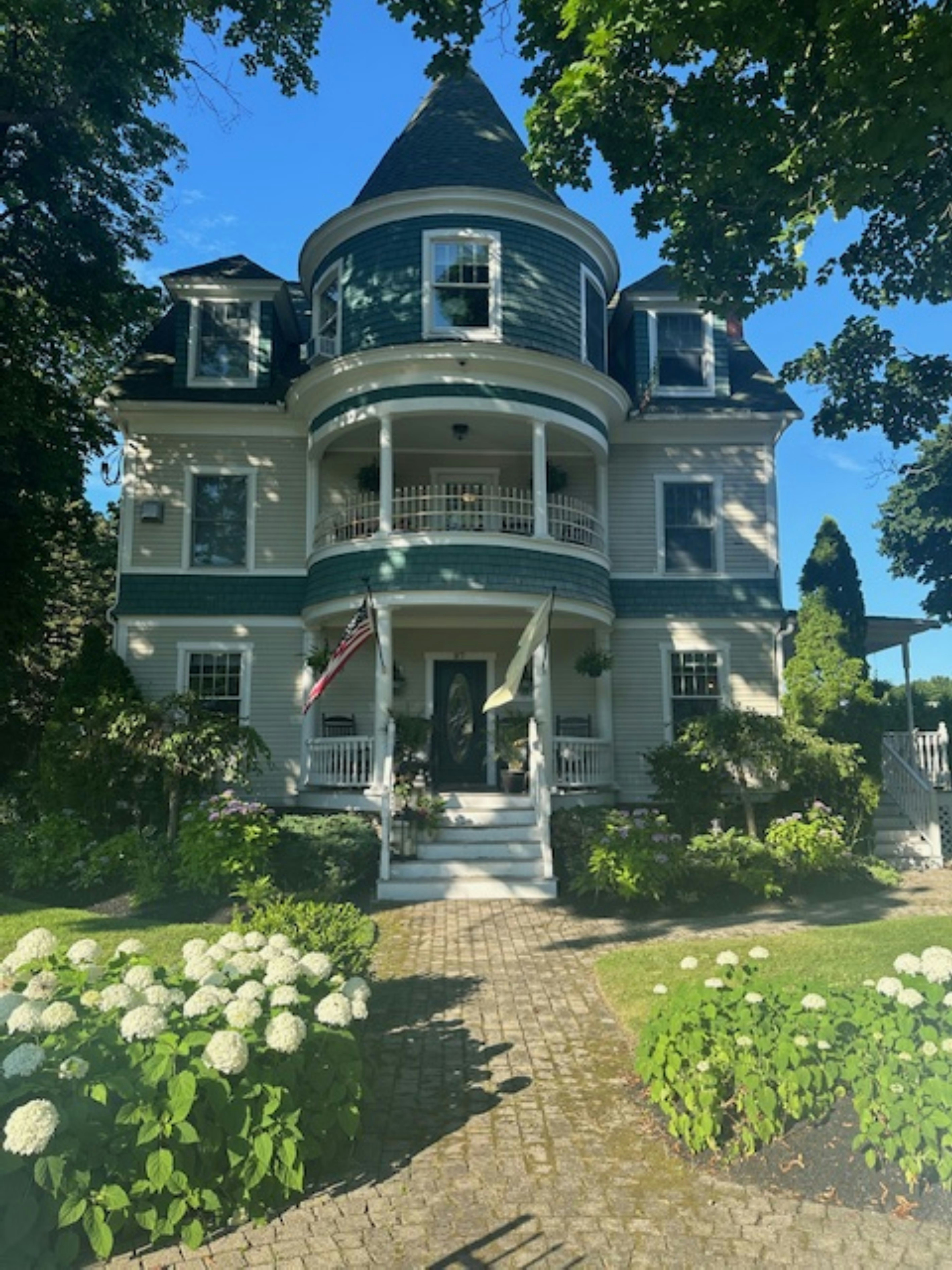 A large white house with a green roof