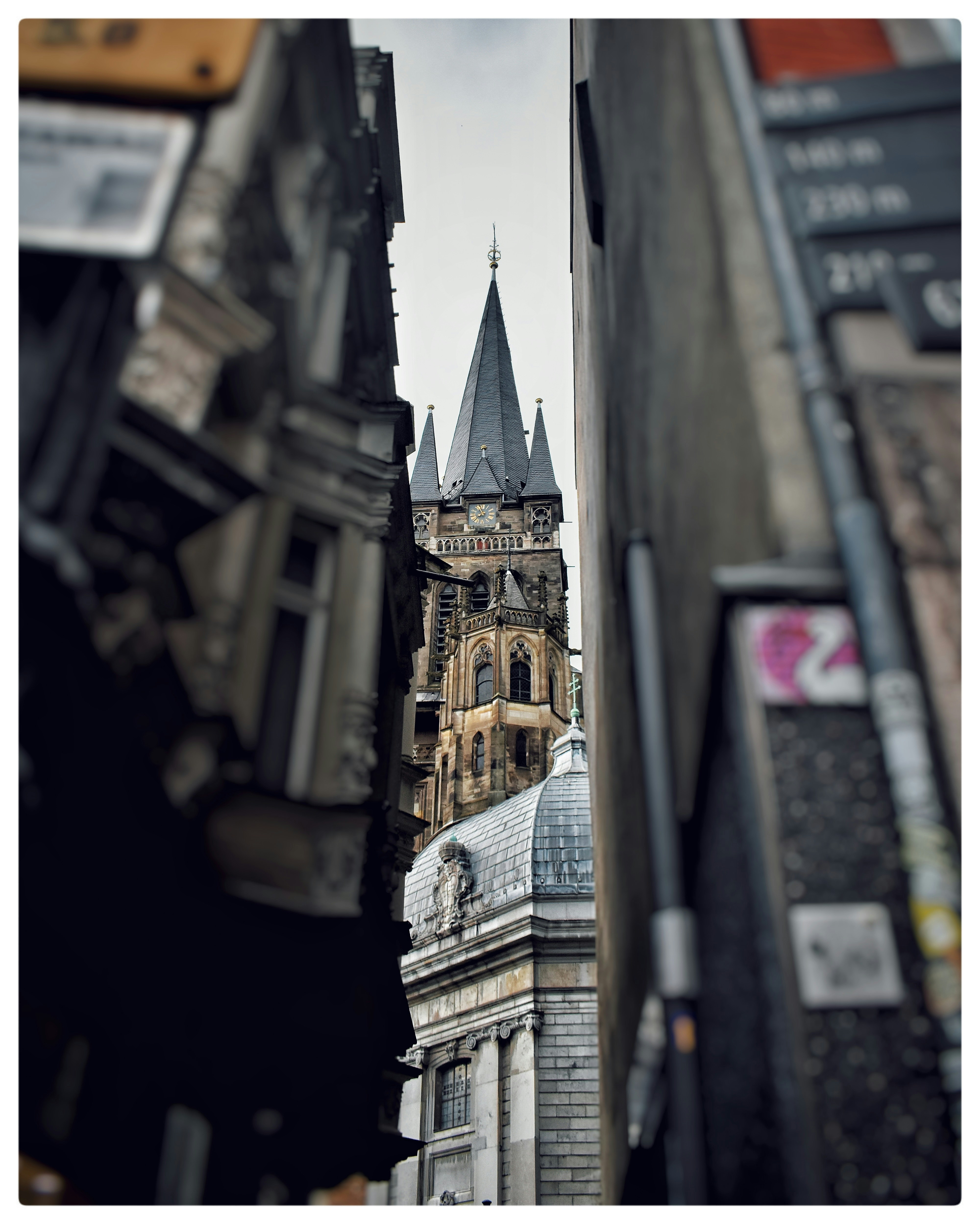 A tall building with a clock tower next to other buildings
