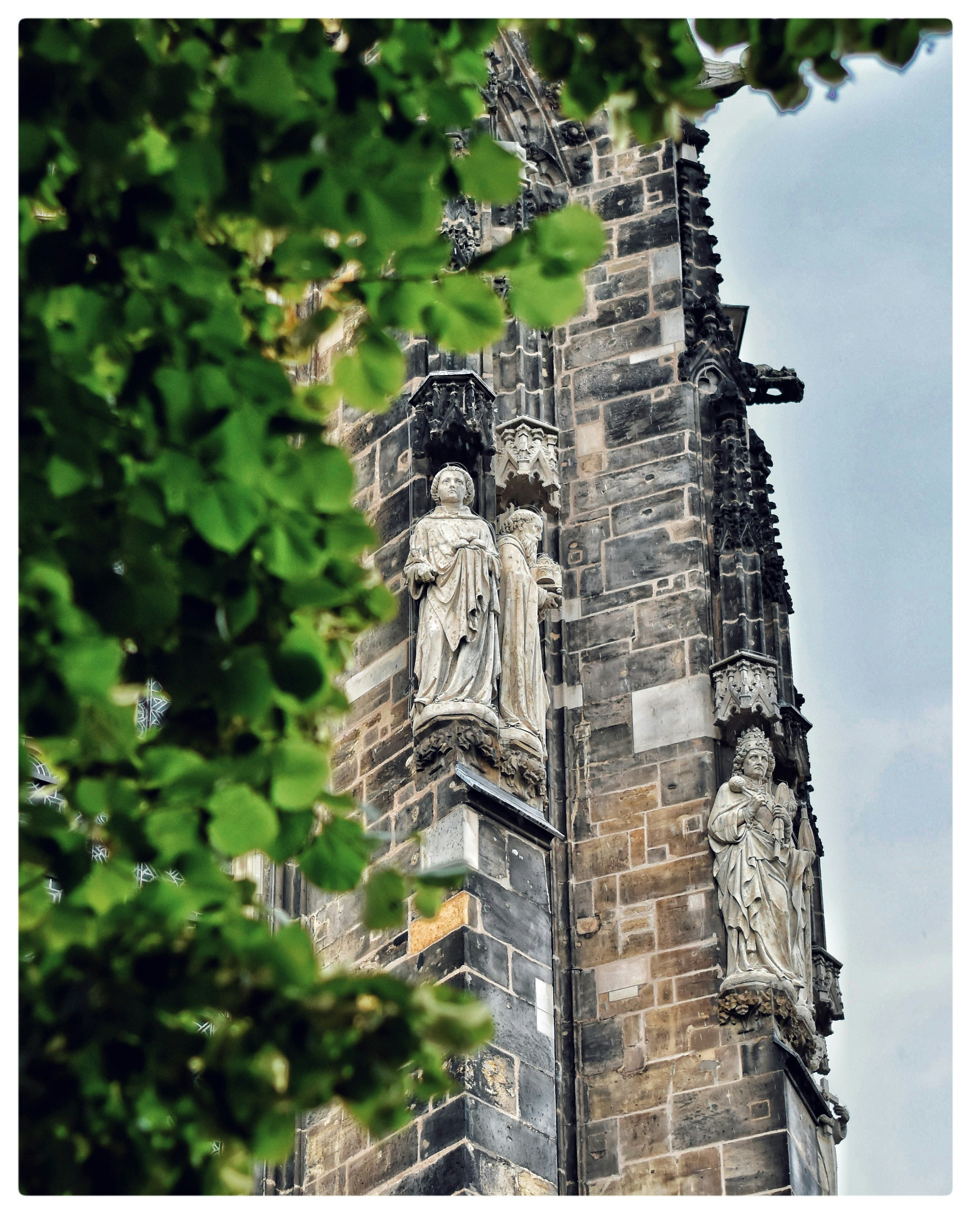 A tall building with statues on the side of it
