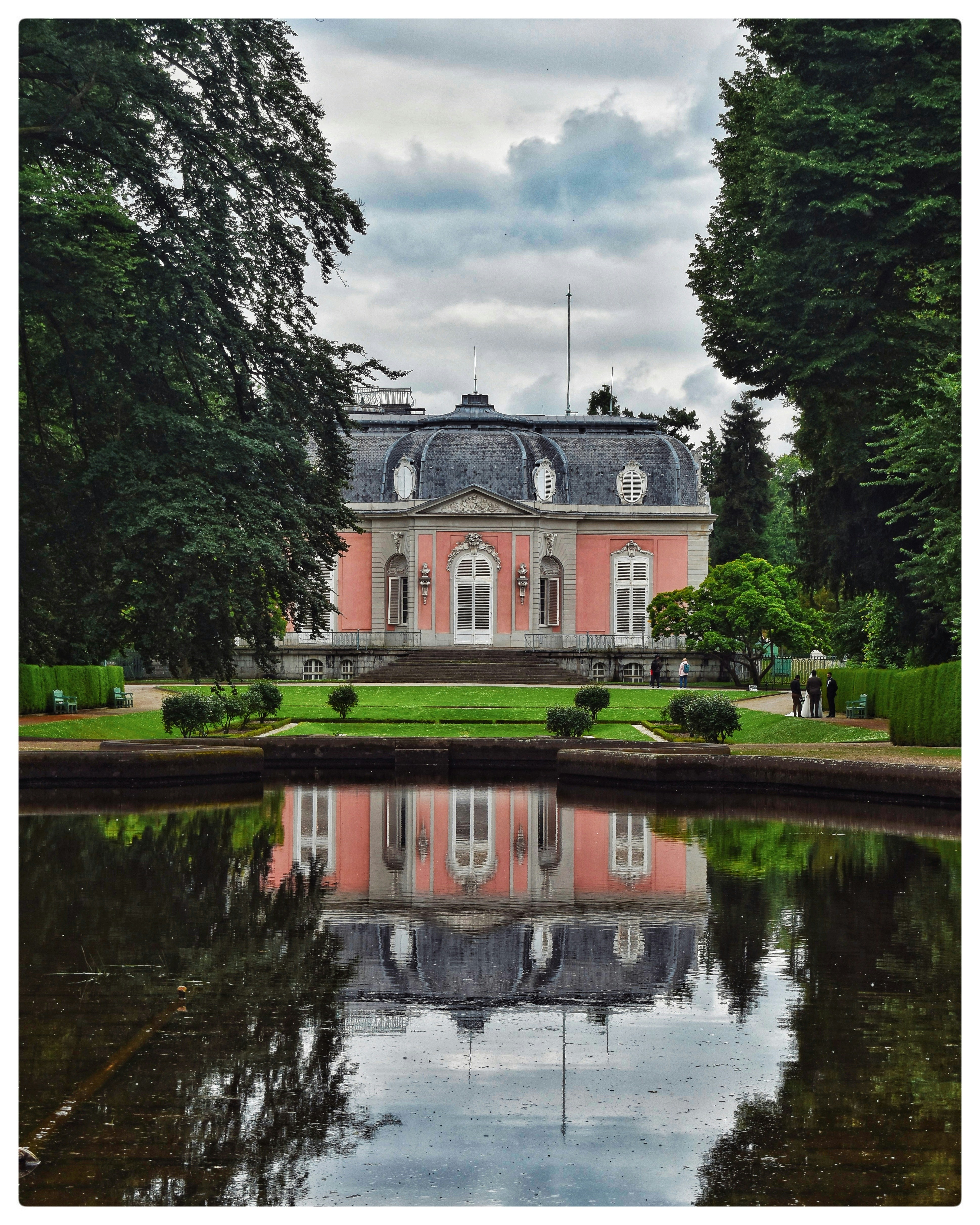 A large building with a pond in front of it