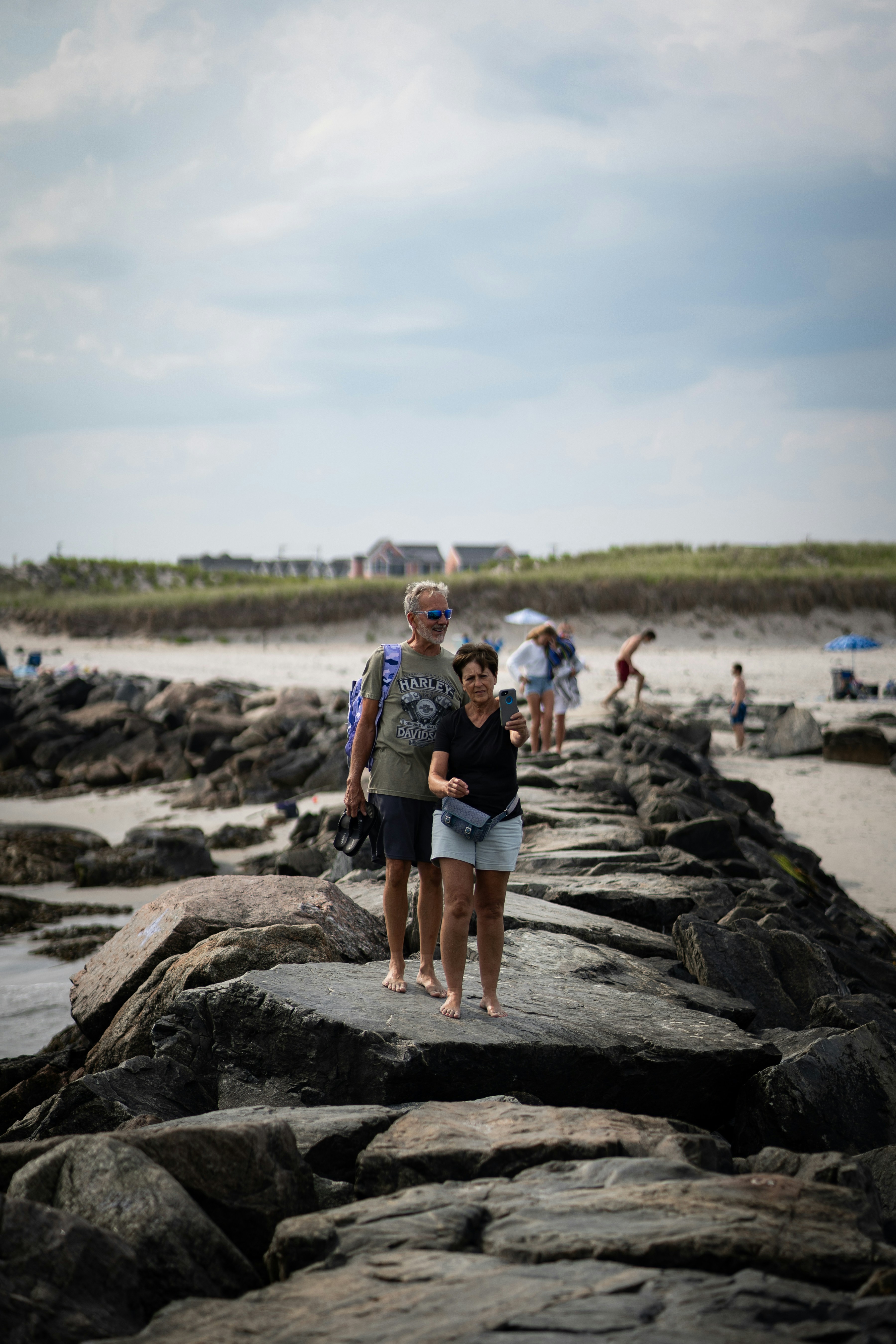 A group of people standing on top of a rocky beach
