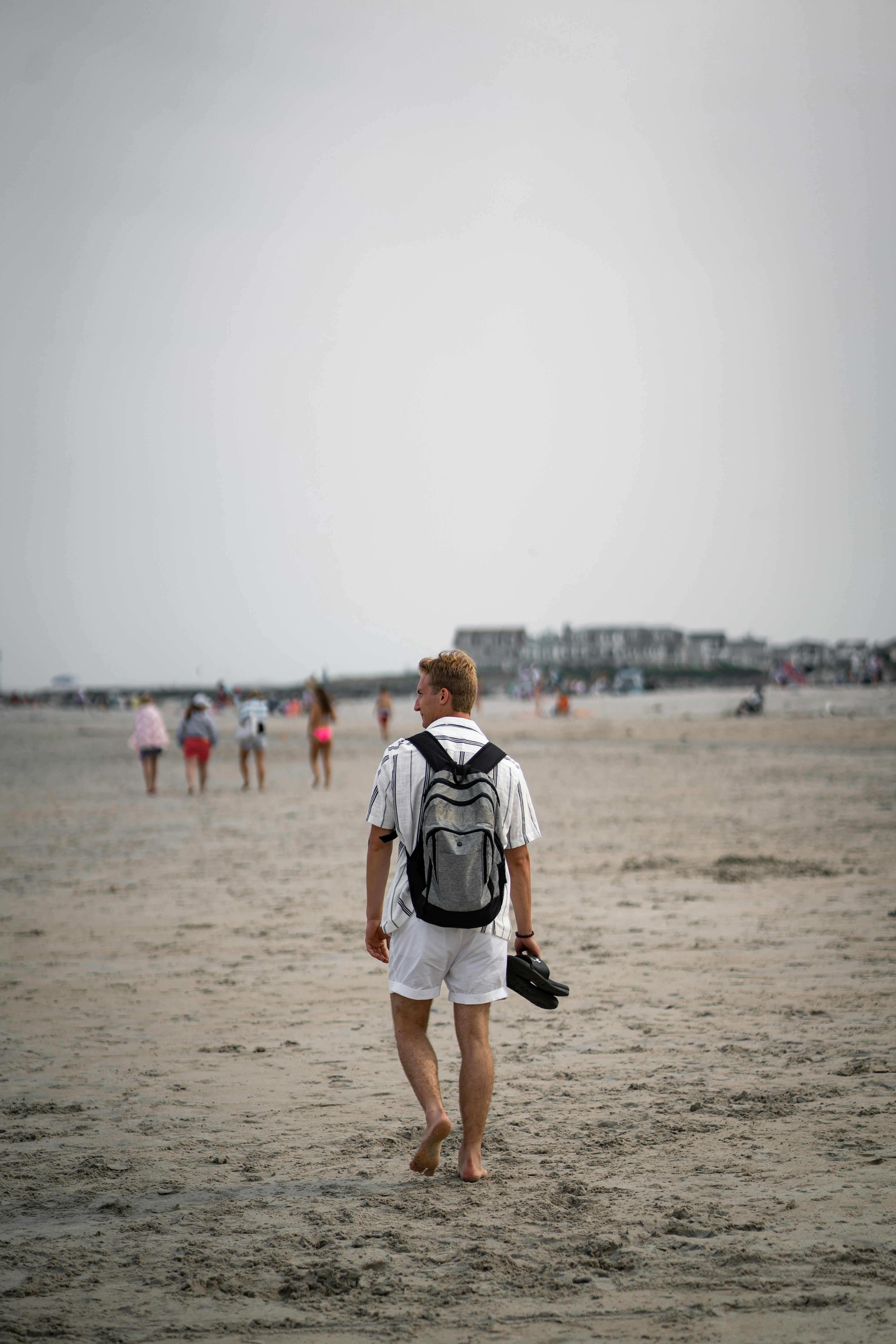 A man standing on top of a sandy beach