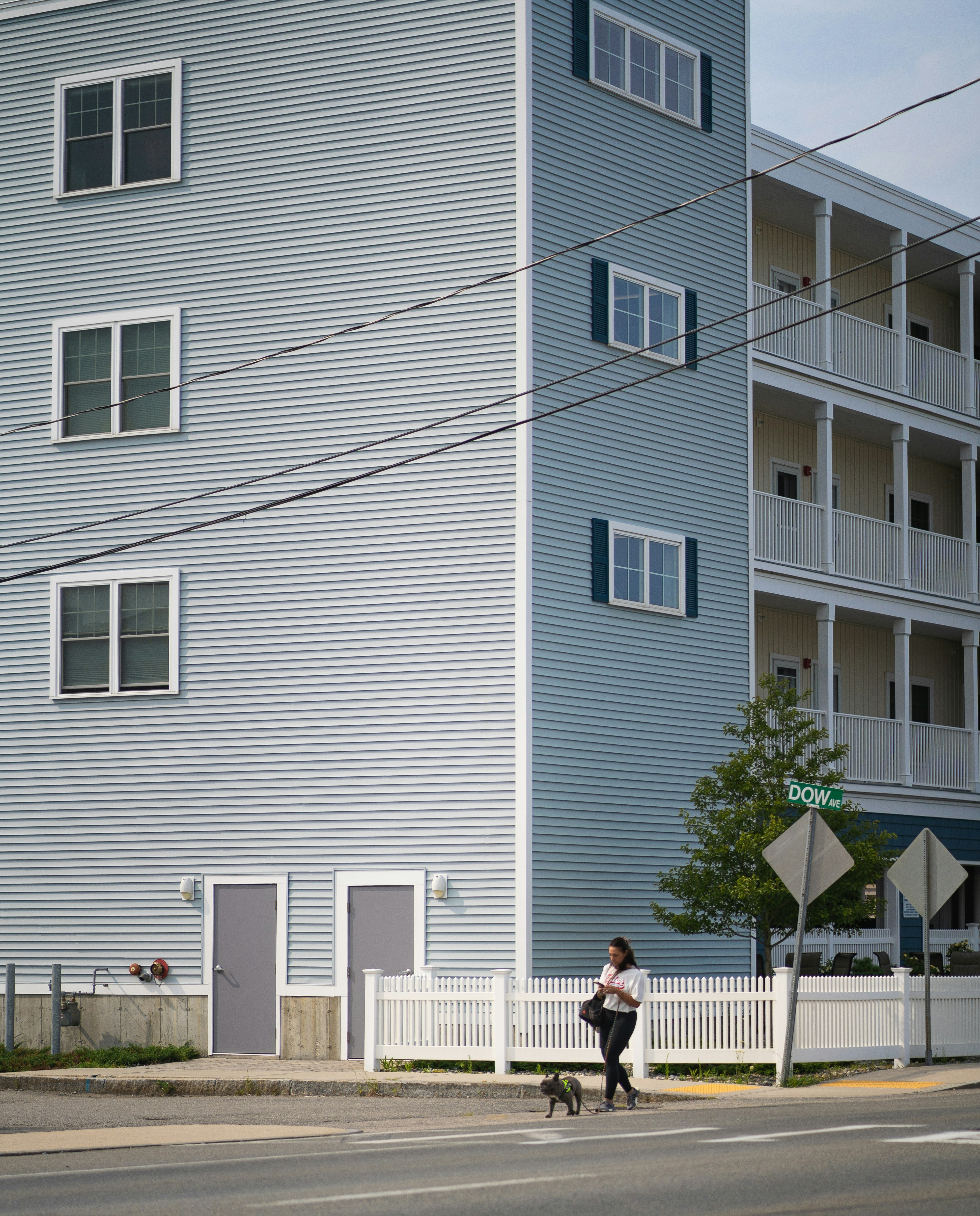 A person crossing the street in front of a building