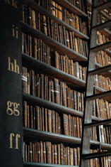 A bookshelf filled with lots of books in a library