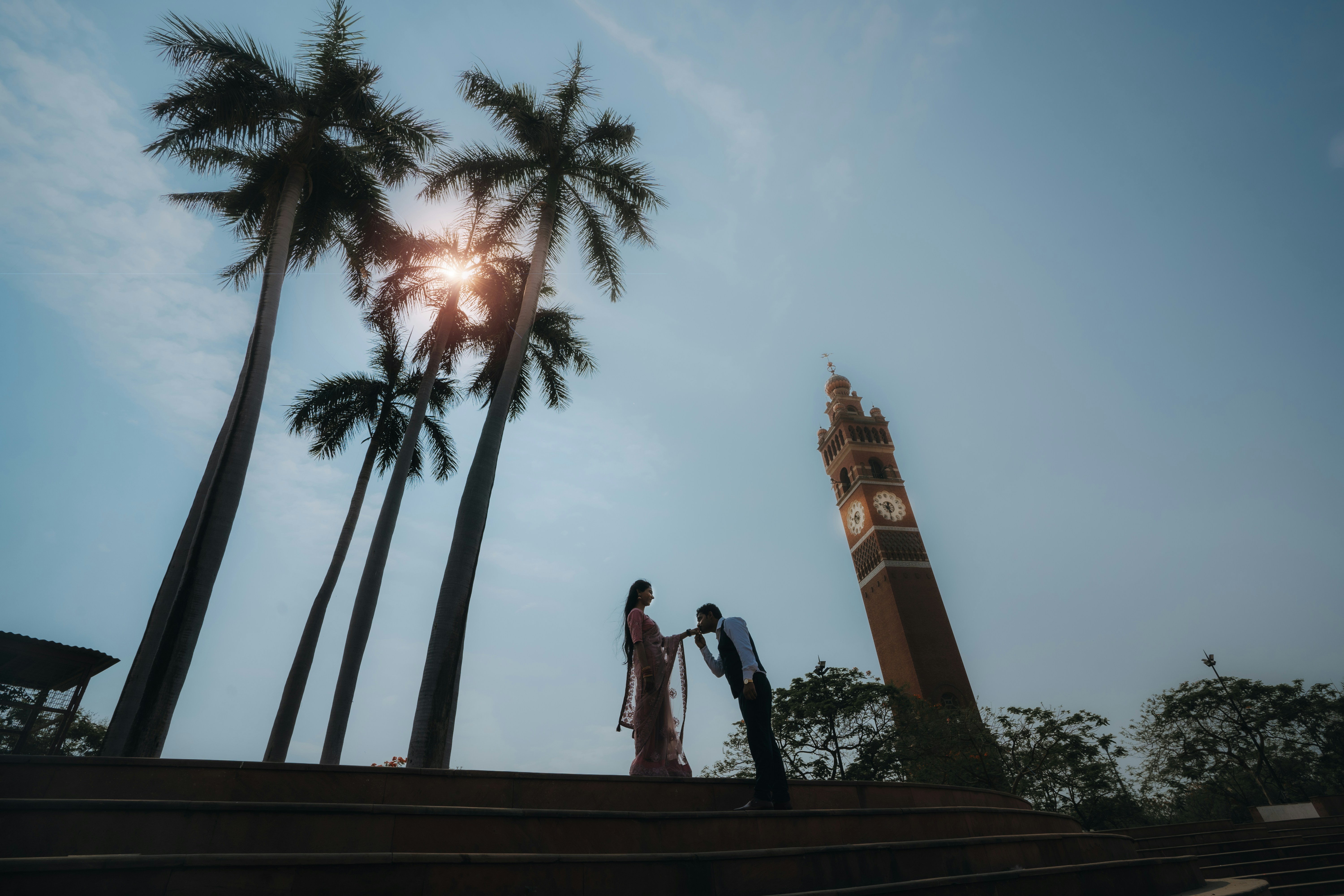 A man and a woman are standing on a bridge