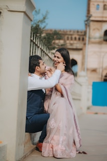 A man kneeling down next to a woman