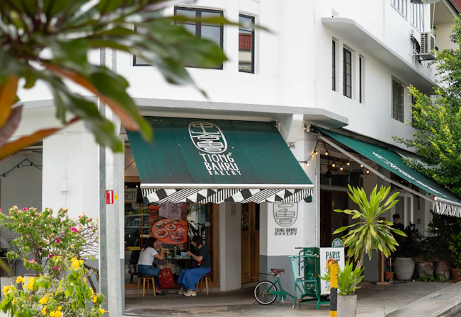 A street corner with a store front and green awnings
