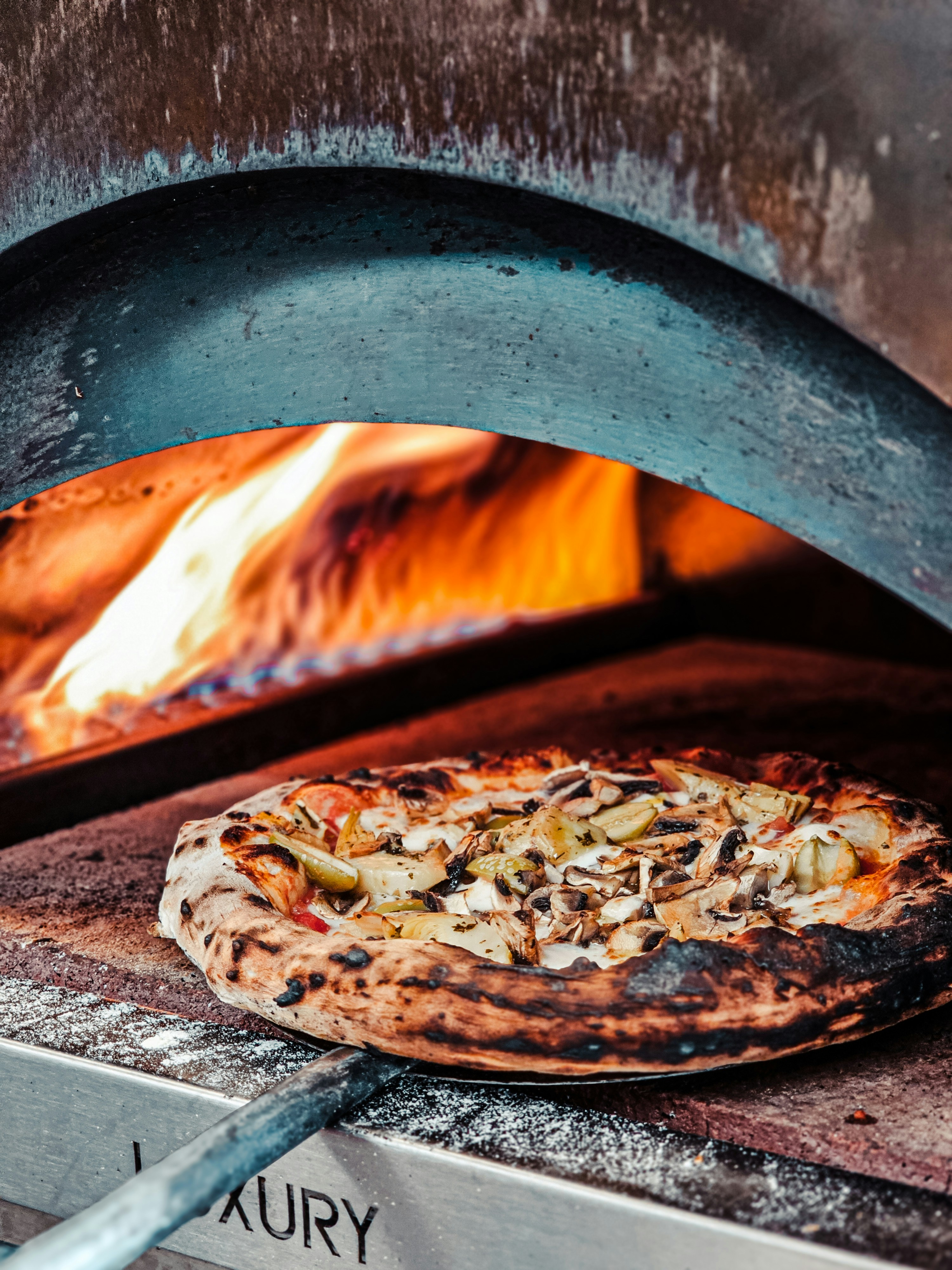 A pizza is cooking in a brick oven