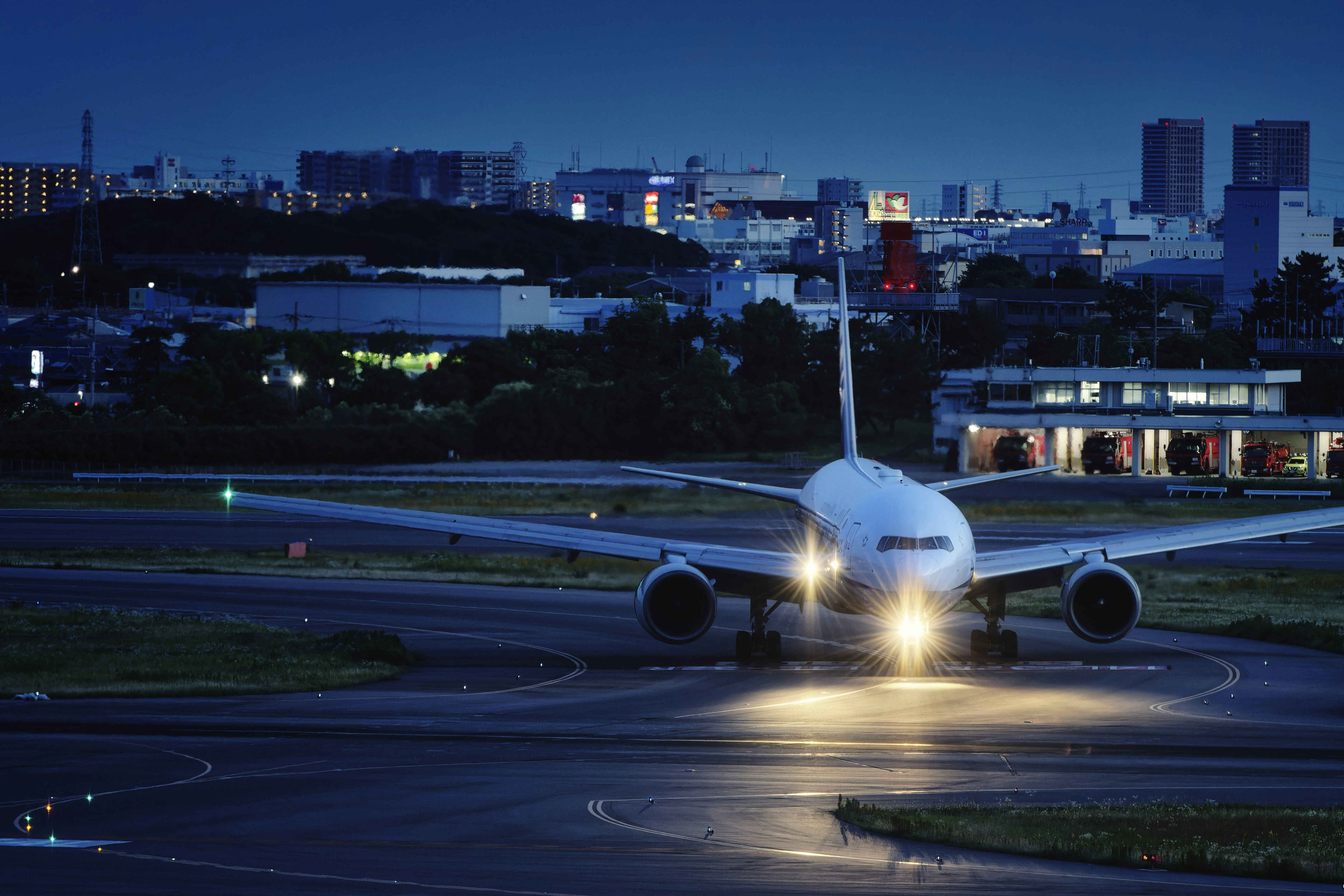 A large jetliner sitting on top of an airport runway, 