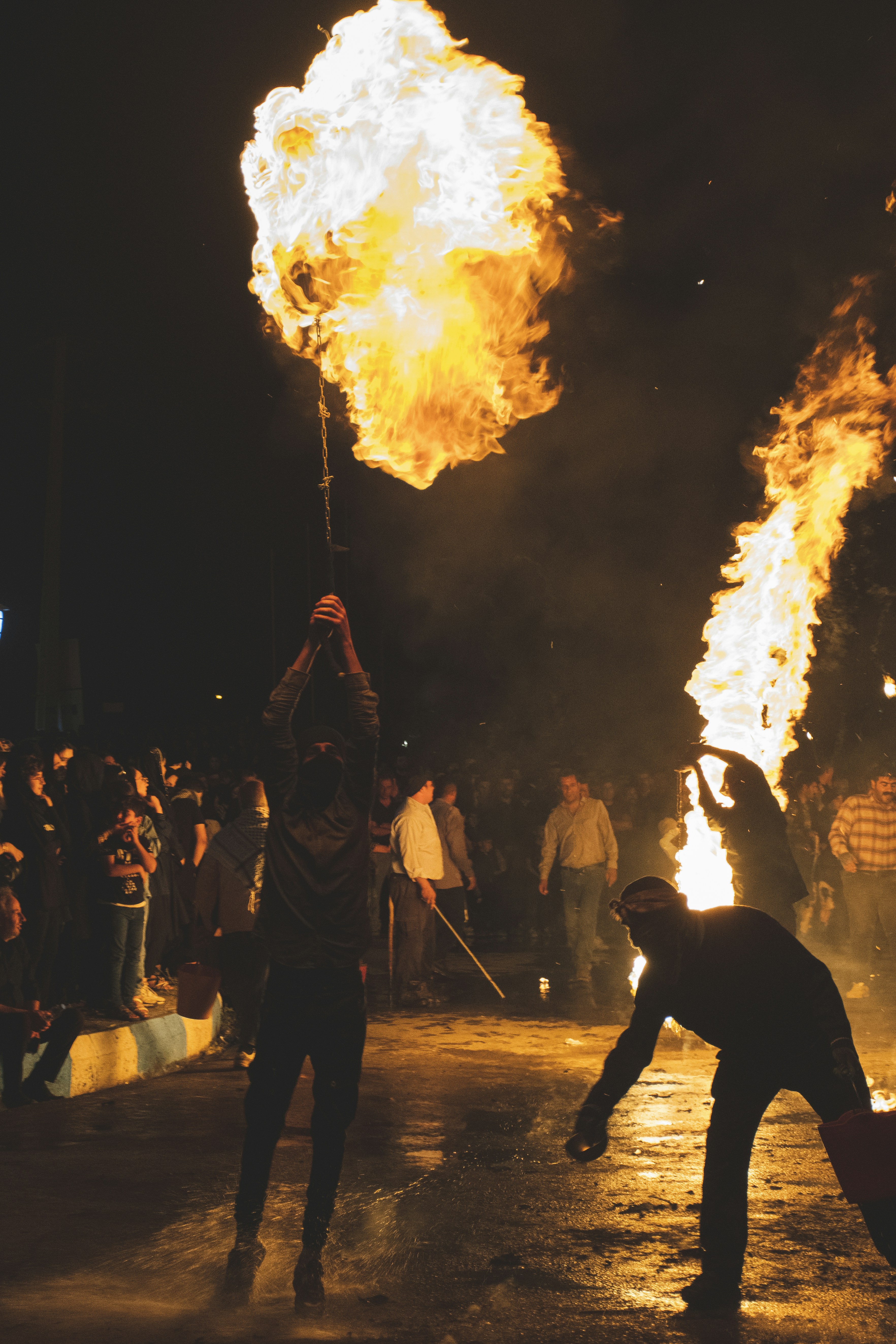 A group of people standing around a fire pit