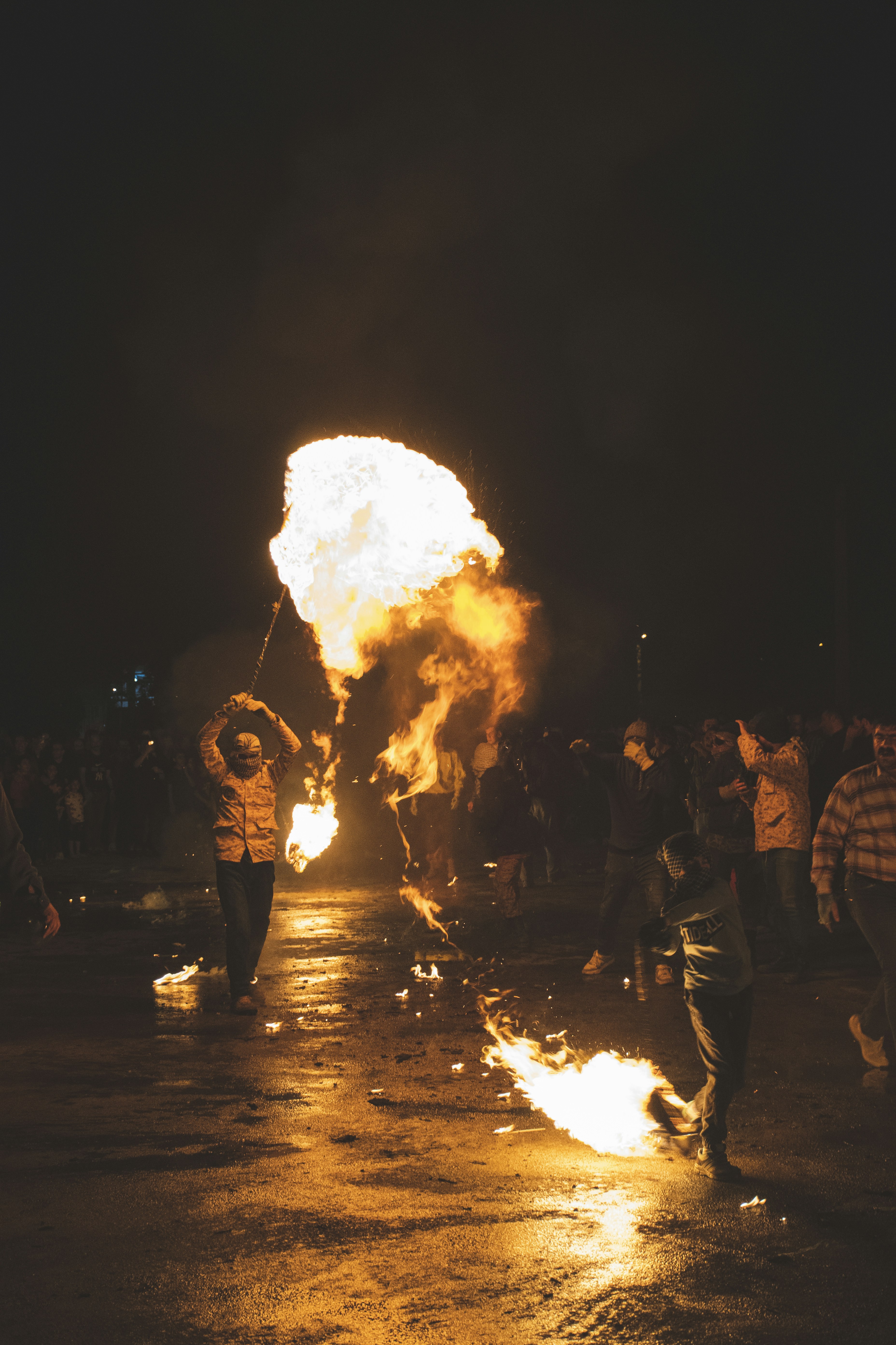 A group of people standing around a fire pit