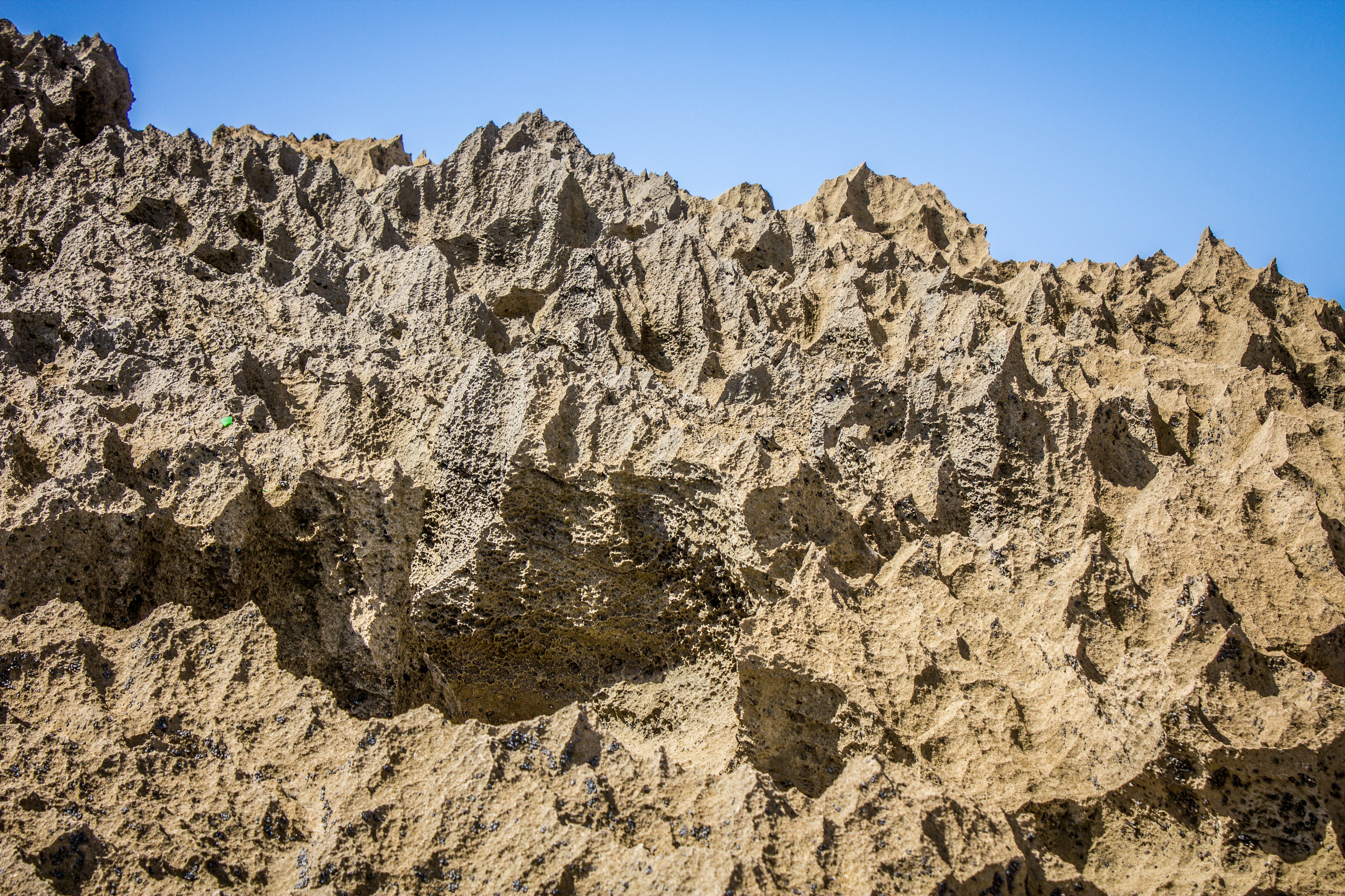 A rock formation with a blue sky in the background