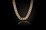 A gold chain on a black background