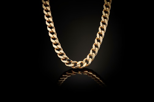 A gold chain on a black background