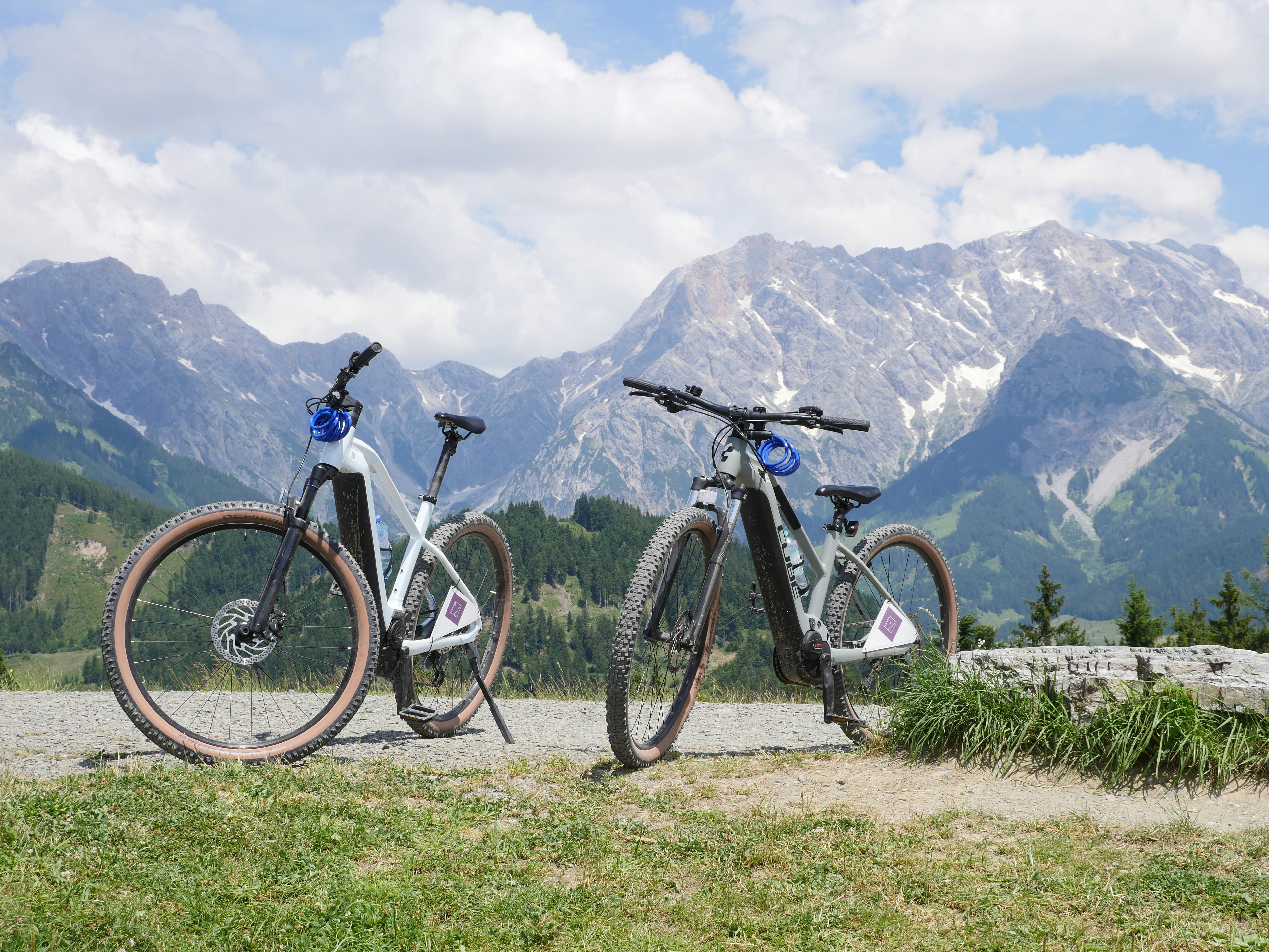 Two bikes parked next to each other in front of mountains