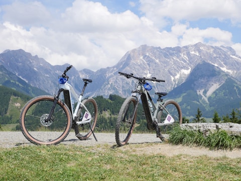 Two bikes parked next to each other in front of mountains