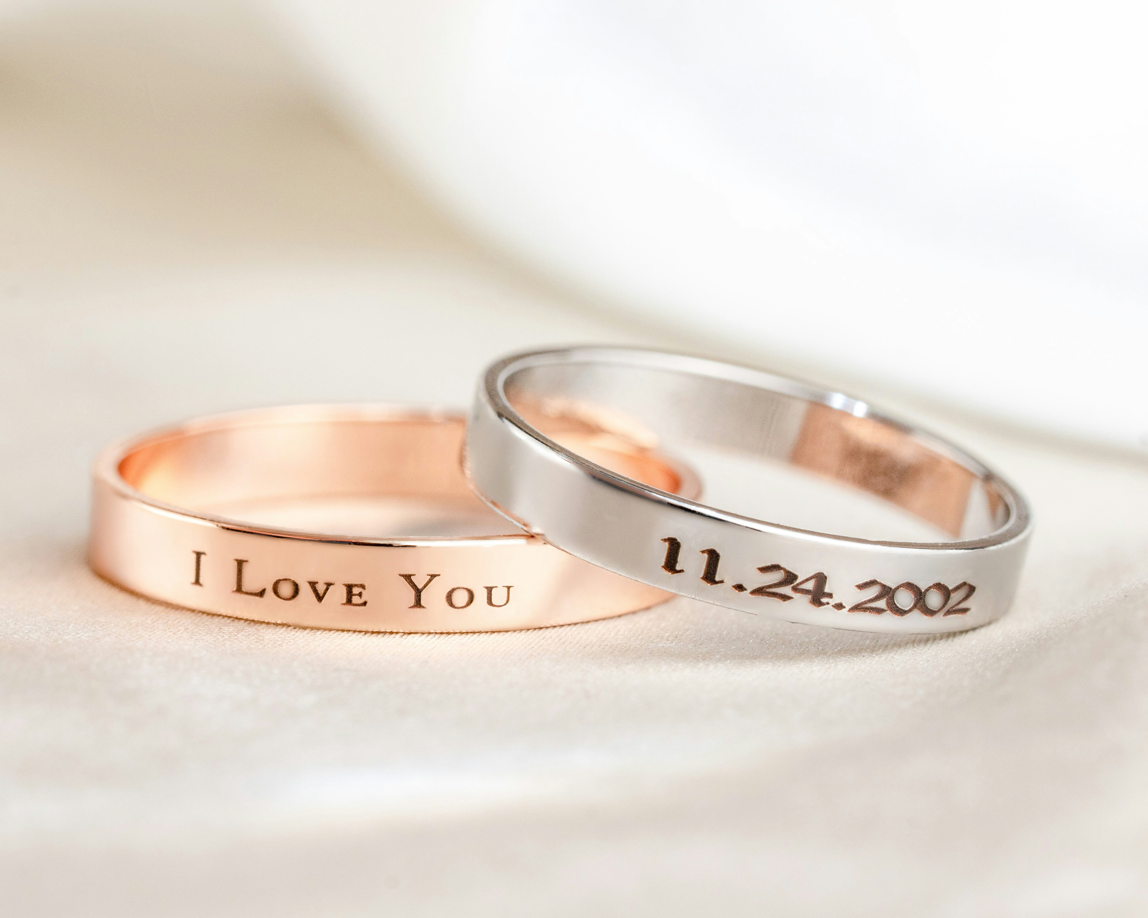 Two wedding rings with i love you written on them