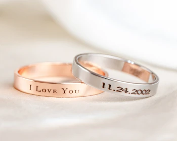 Two wedding rings with i love you written on them
