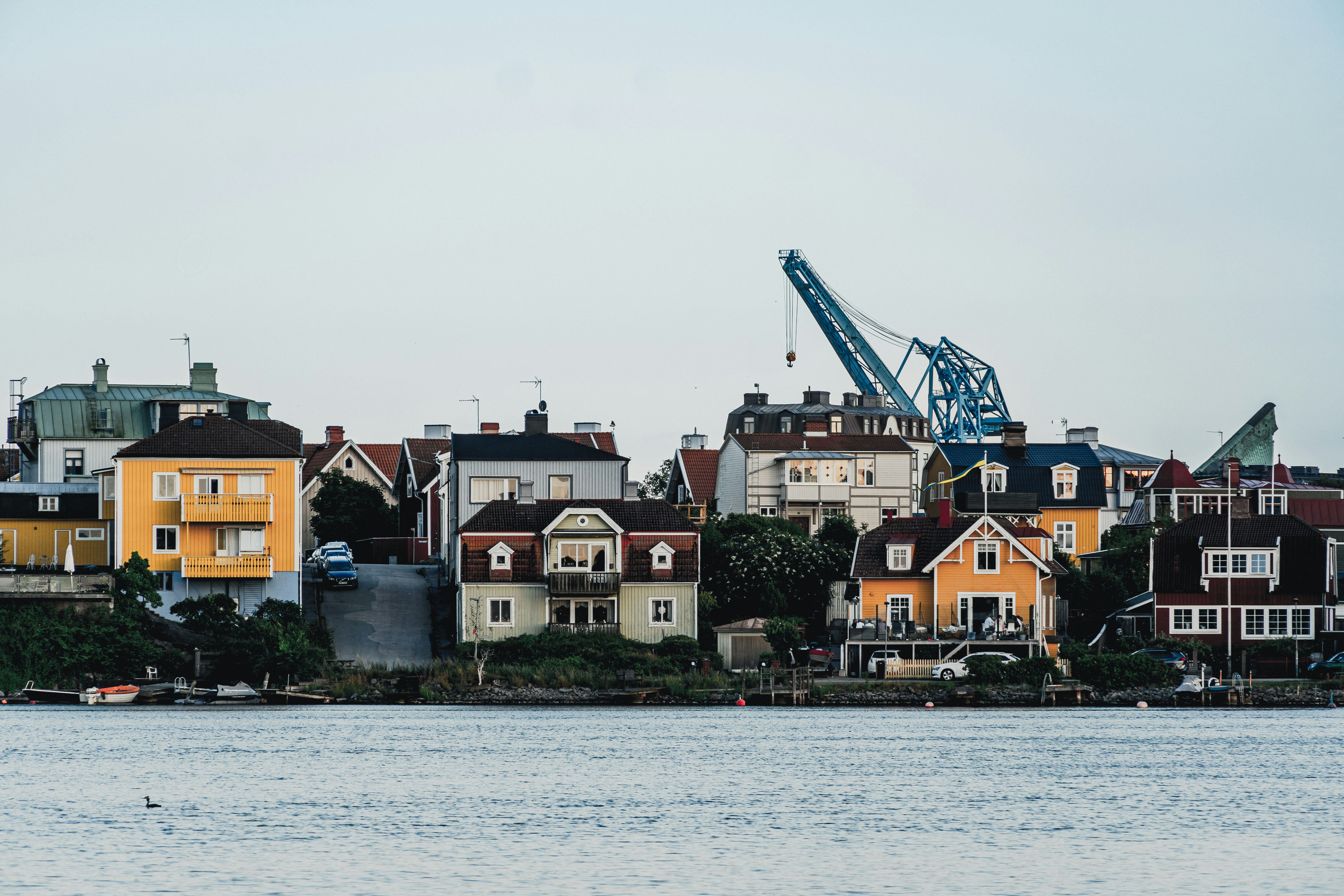 A large body of water with houses in the background