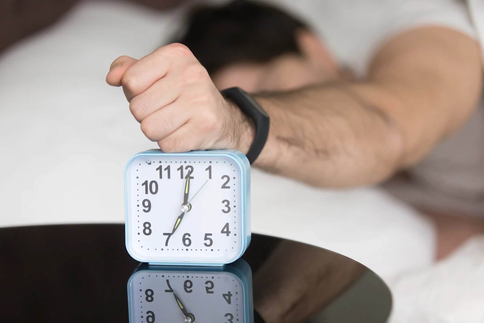 Weary hands resting on clock face, soft shadows revealing emotional labor