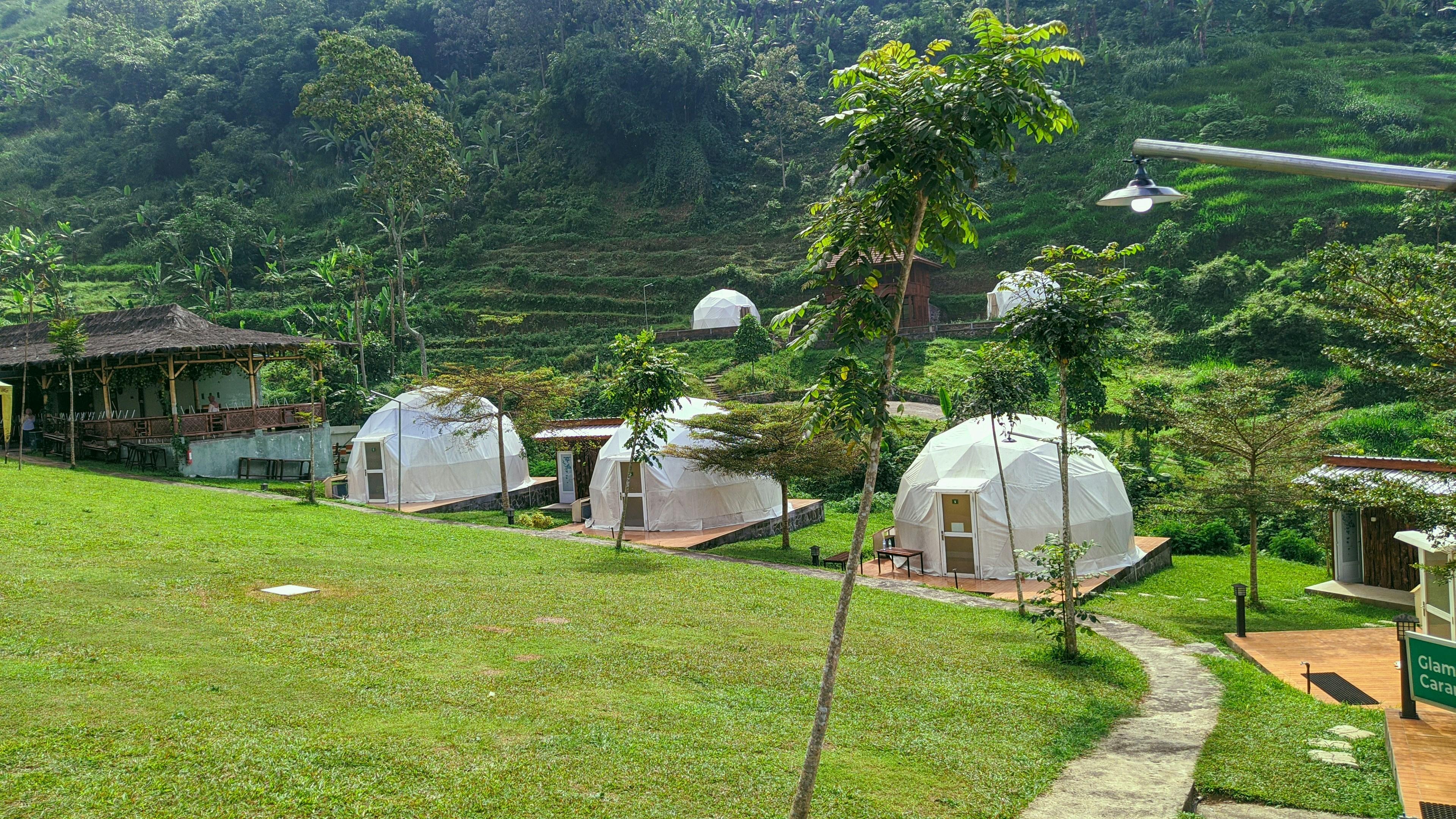 A grassy area with several domes in the middle of it
