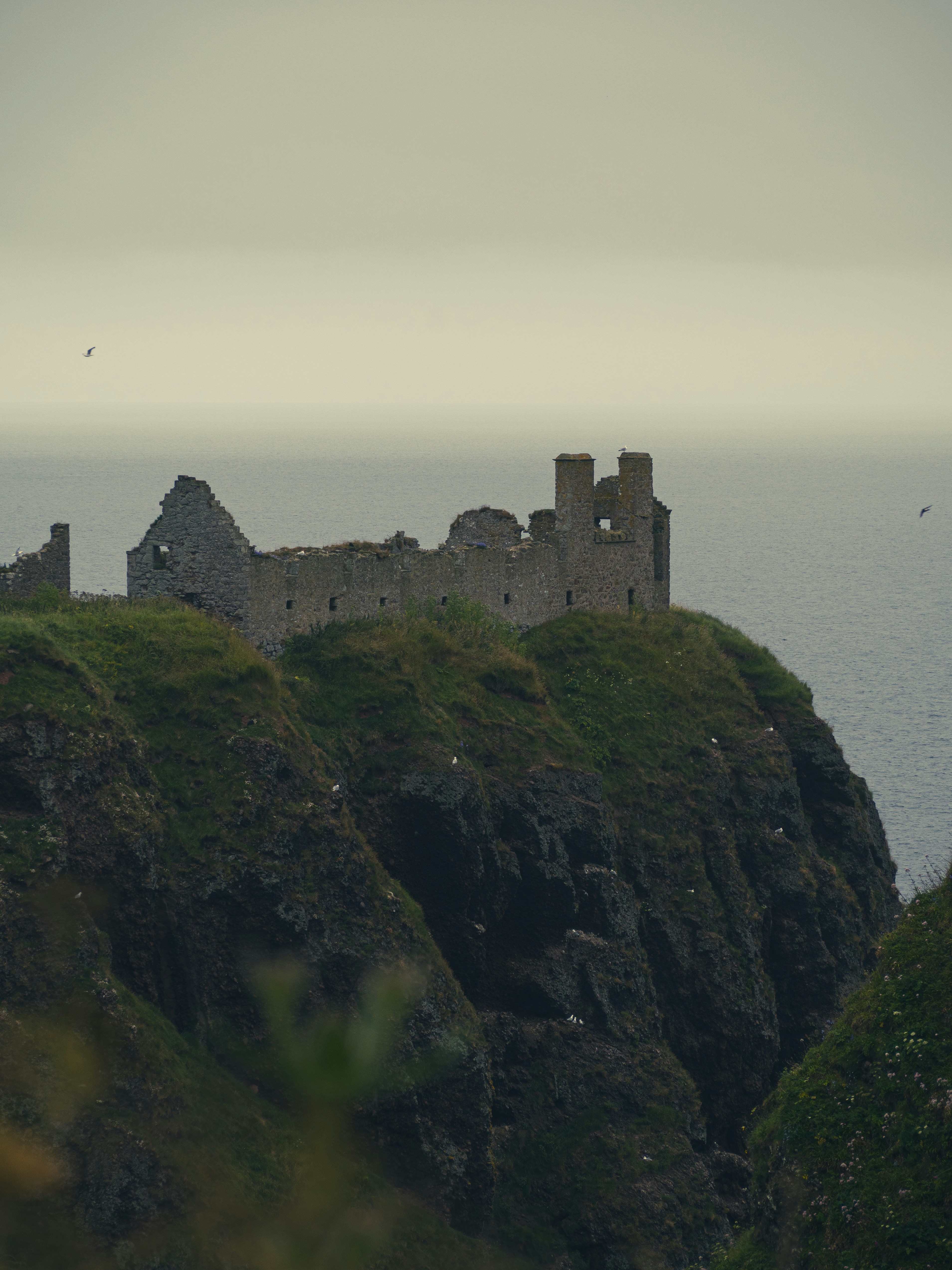 A castle sitting on top of a cliff next to the ocean