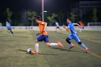 A group of young men playing a game of soccer