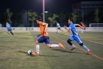 A group of young men playing a game of soccer