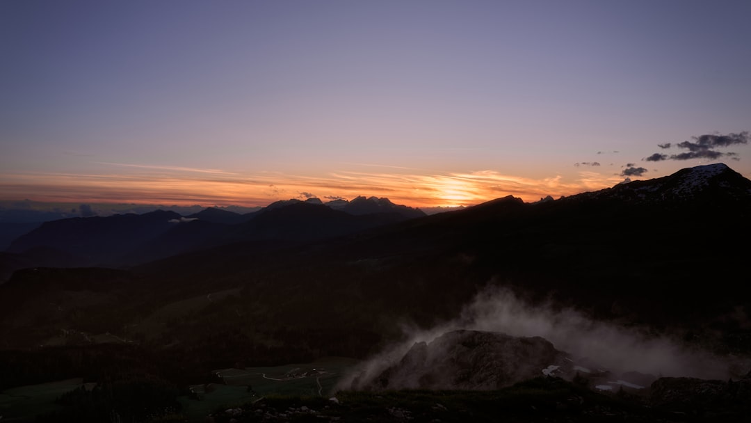The sun is setting over a mountain range