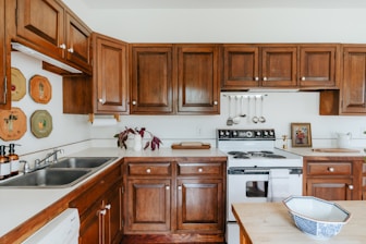 A kitchen with wooden cabinets and white appliances