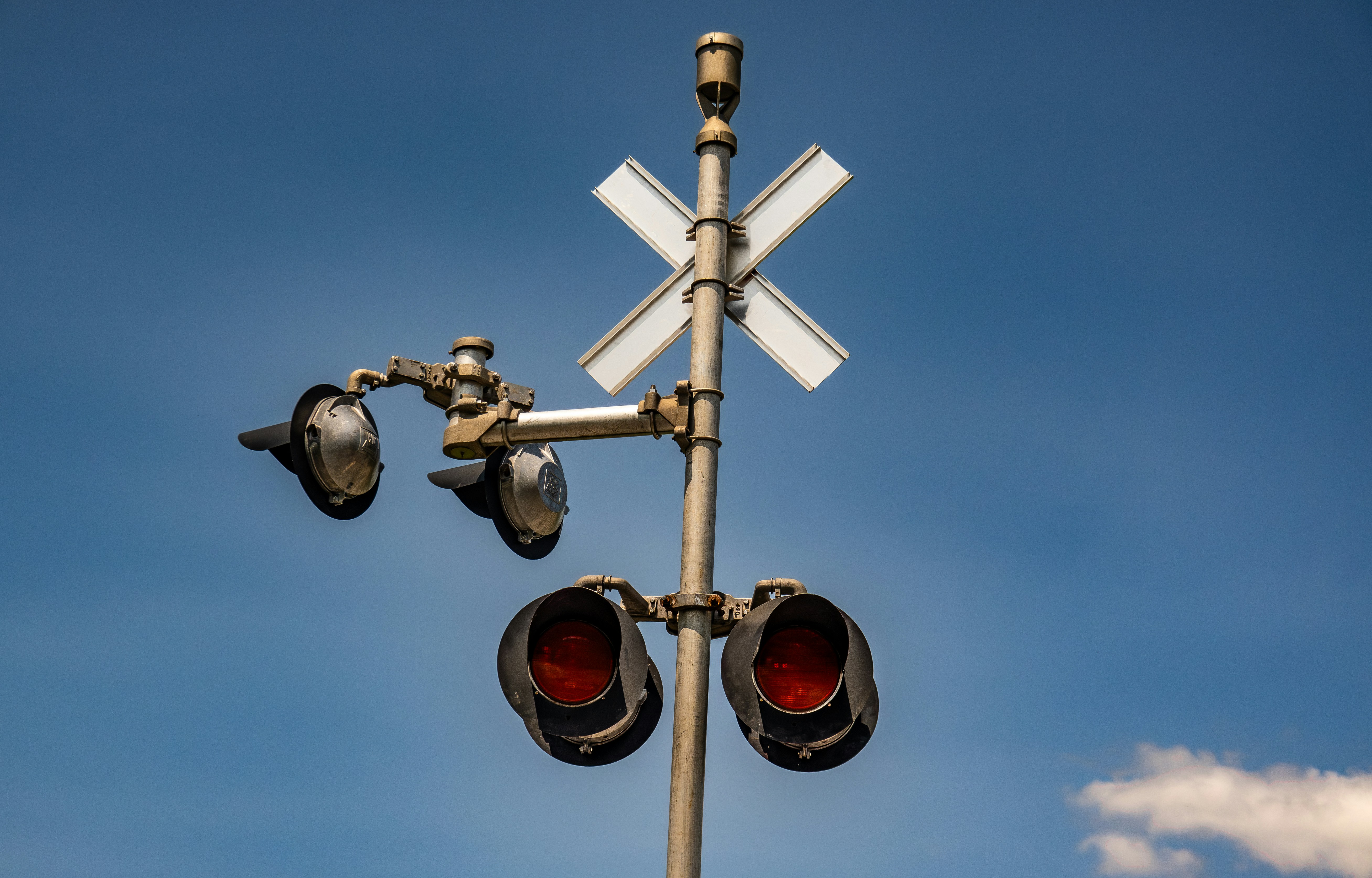 A traffic light with a cross on top of it