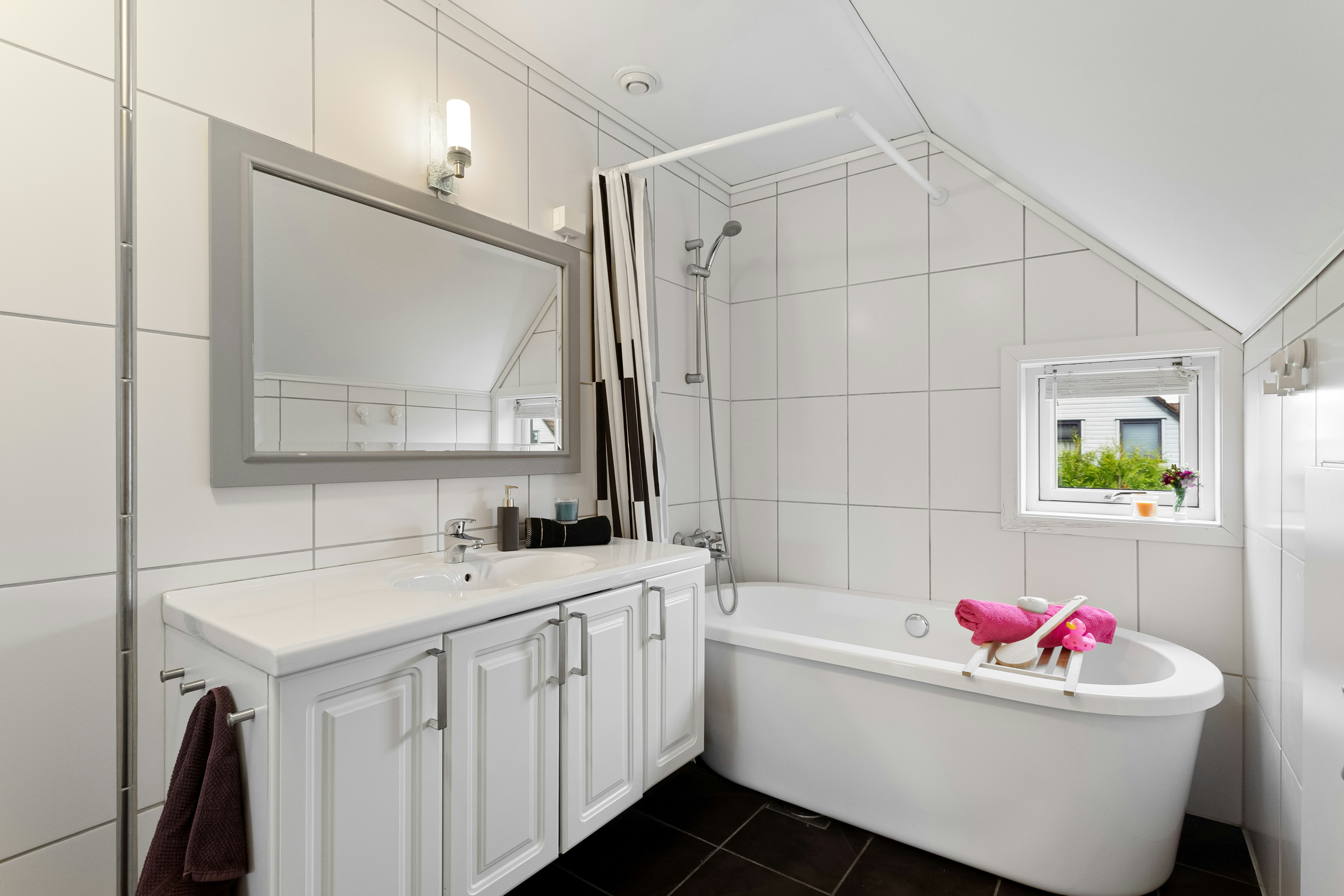 Modern white bathroom with freestanding bathtub, clean white sanitaryware, bright airy minimalist interior