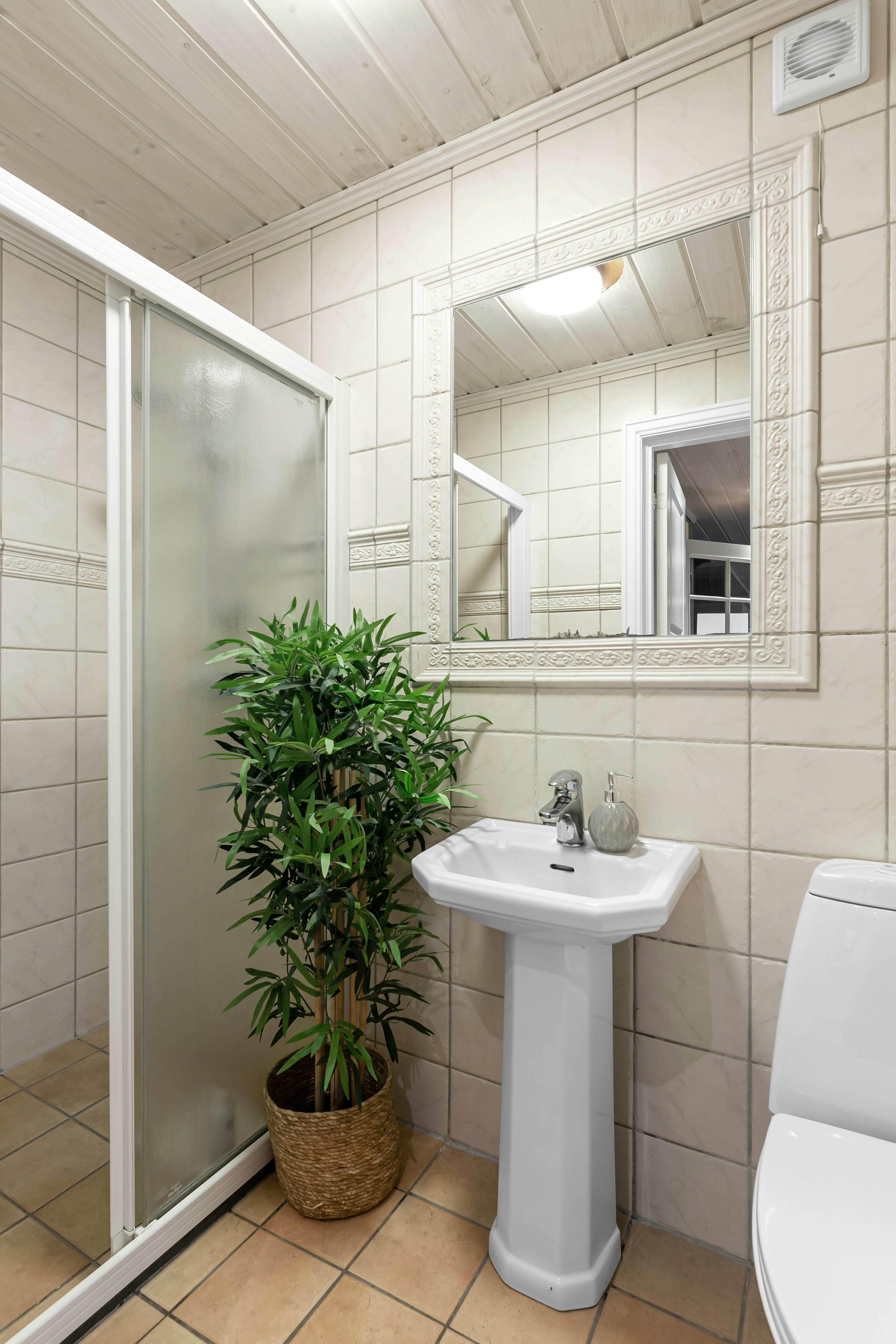 A bathroom with a toilet, sink, and shower