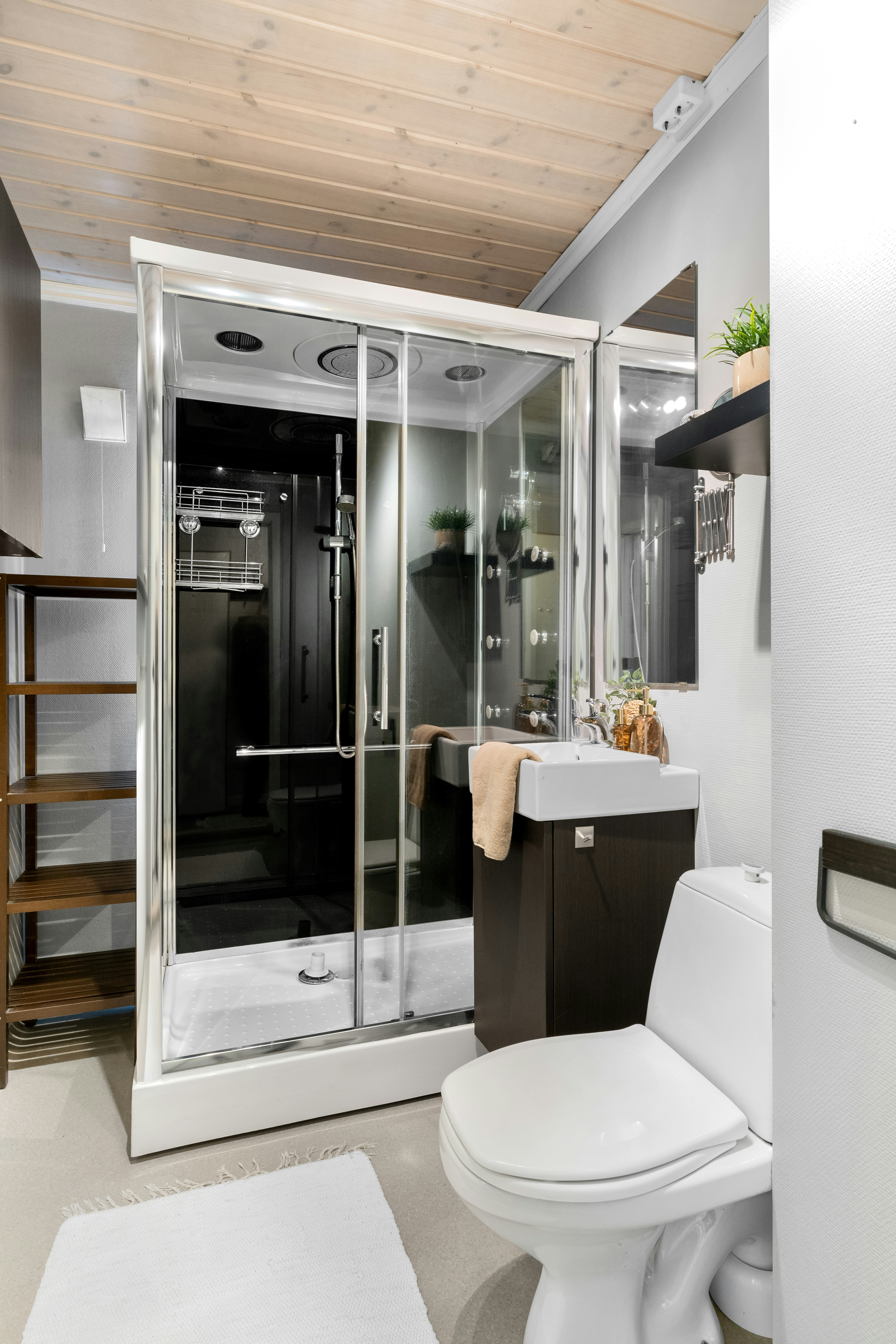 A white toilet sitting next to a walk in shower