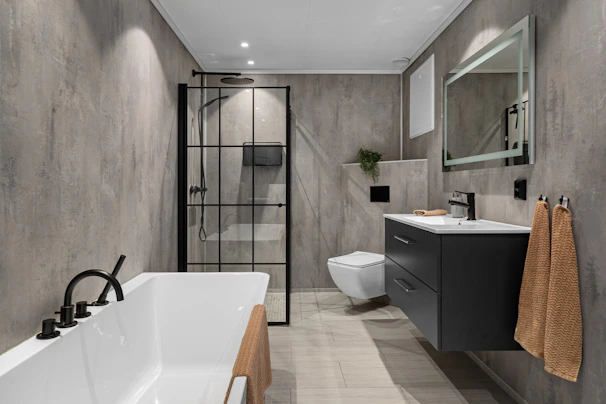 A bathroom with a large bathtub next to a toilet