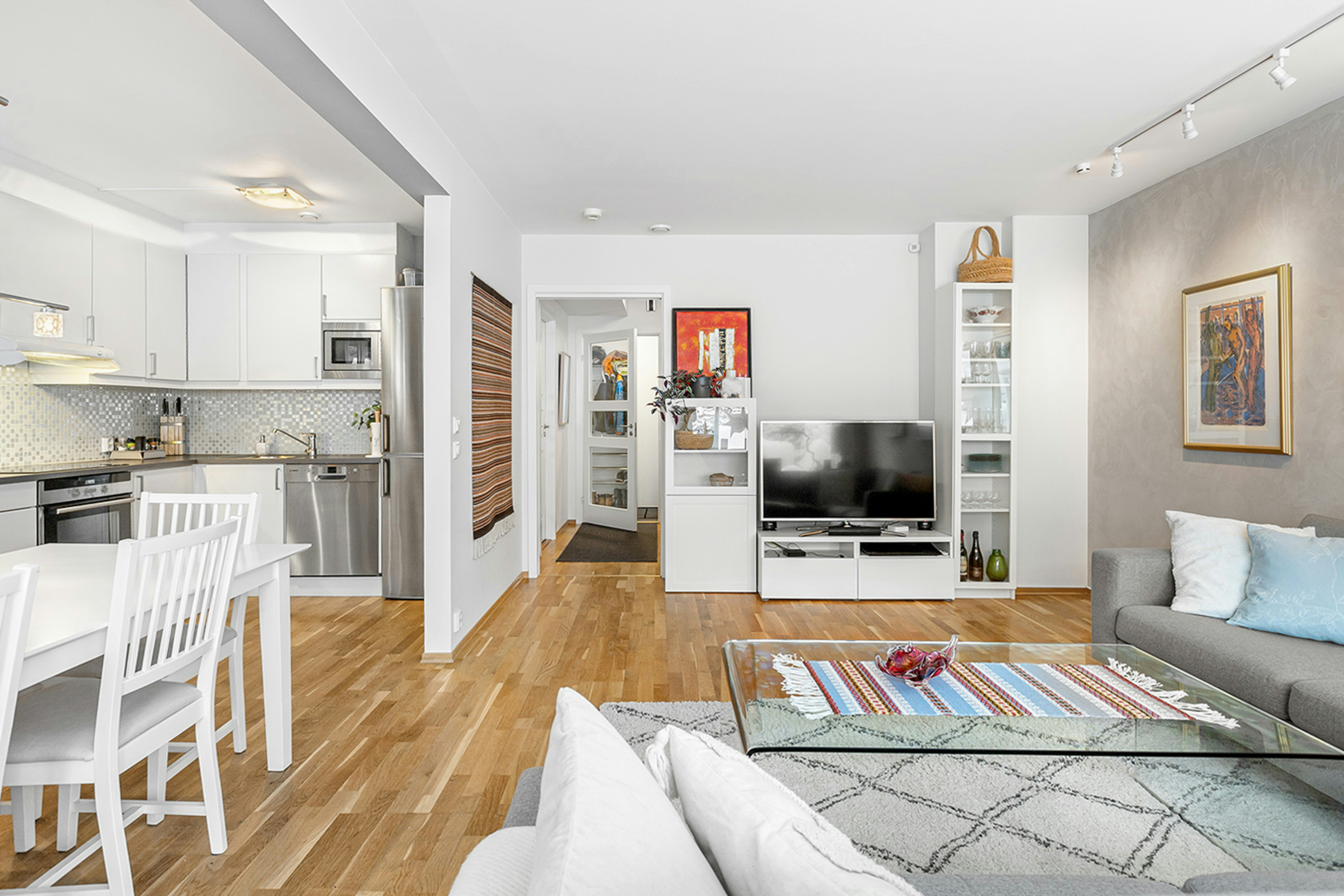 A living room filled with furniture and a flat screen TV