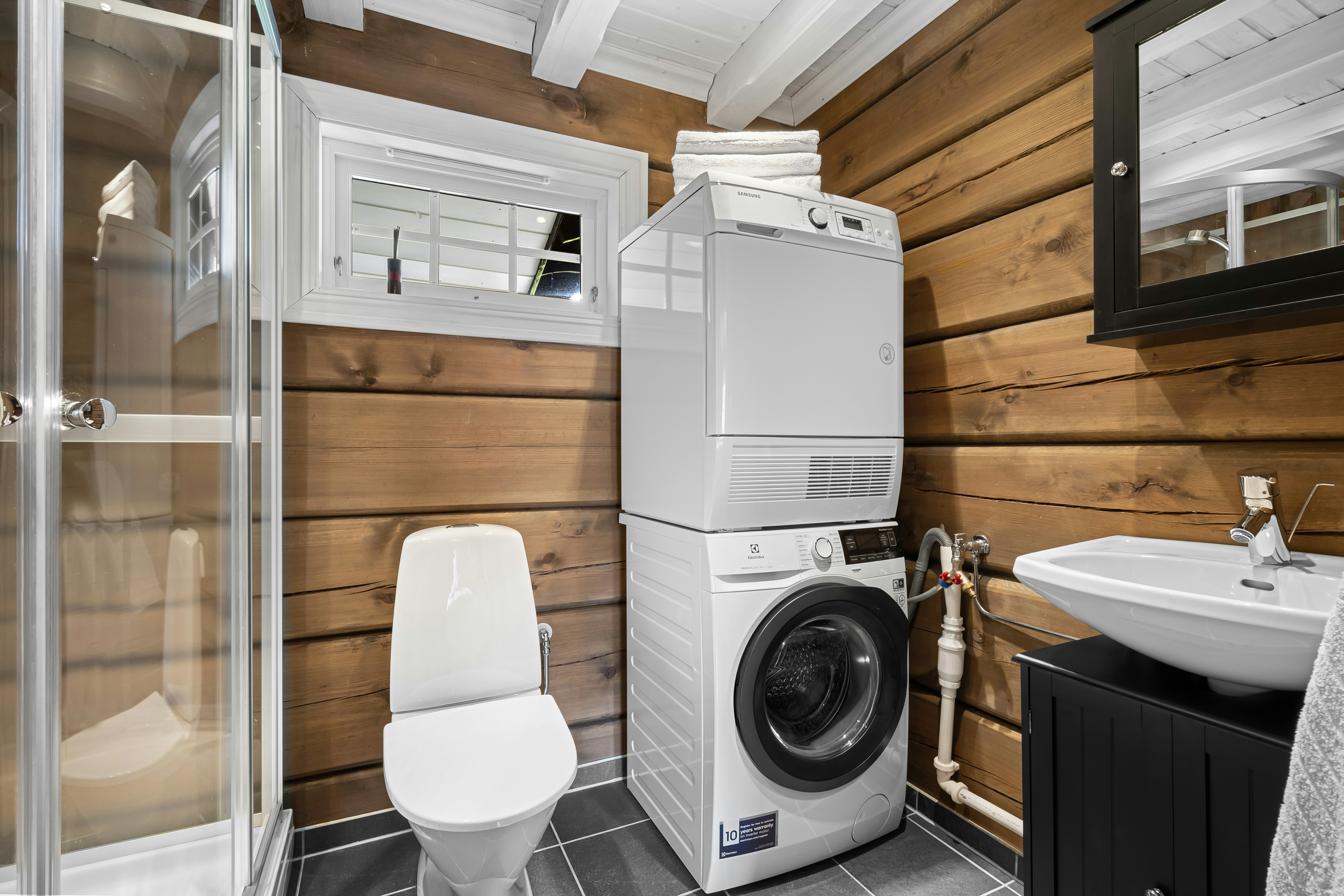 A washer and dryer in a small bathroom