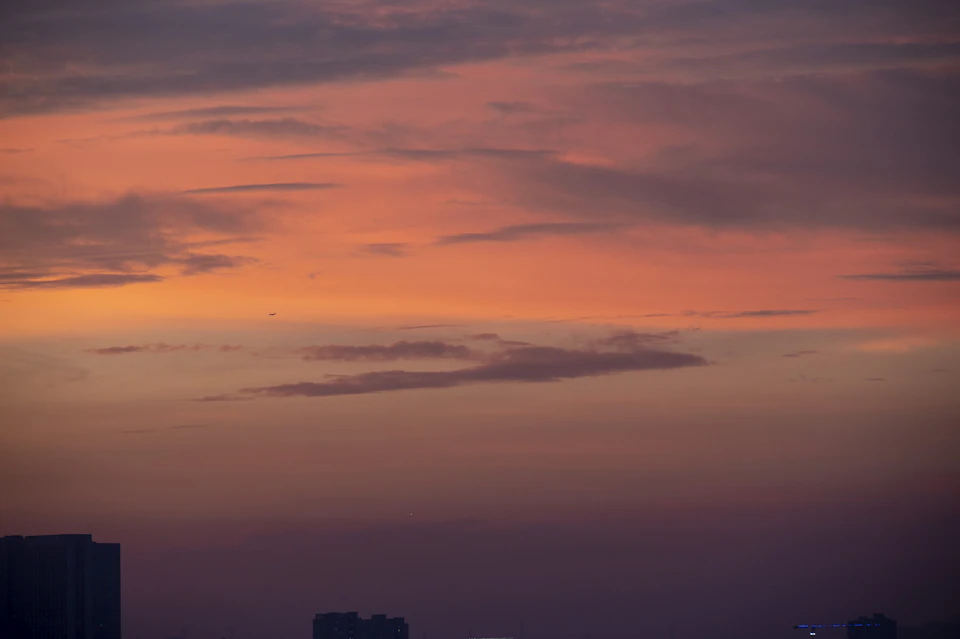 Breathtaking sunset over city skyline with vibrant orange and pink hues in the sky