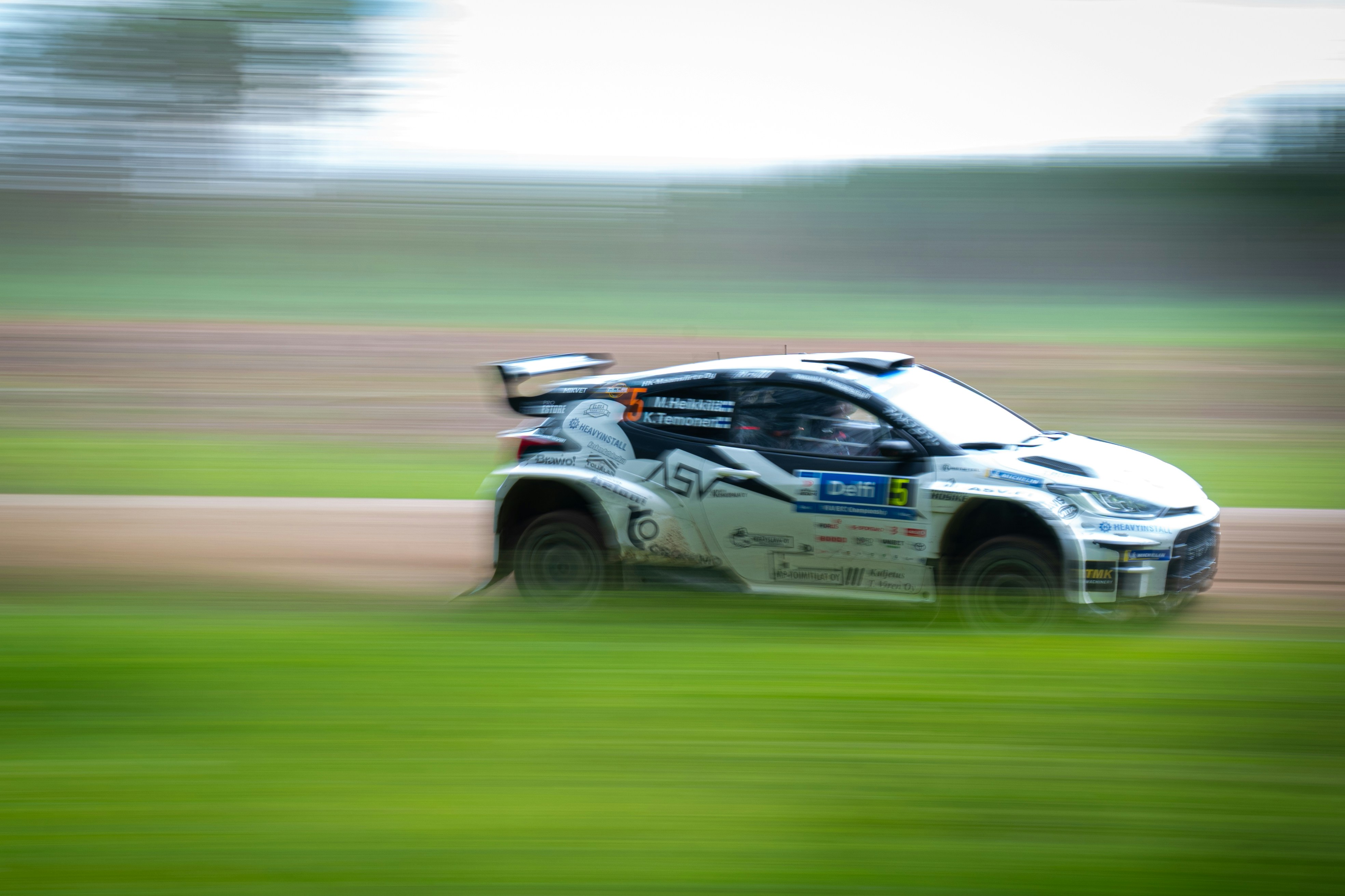 A blurry photo of a car driving on a track