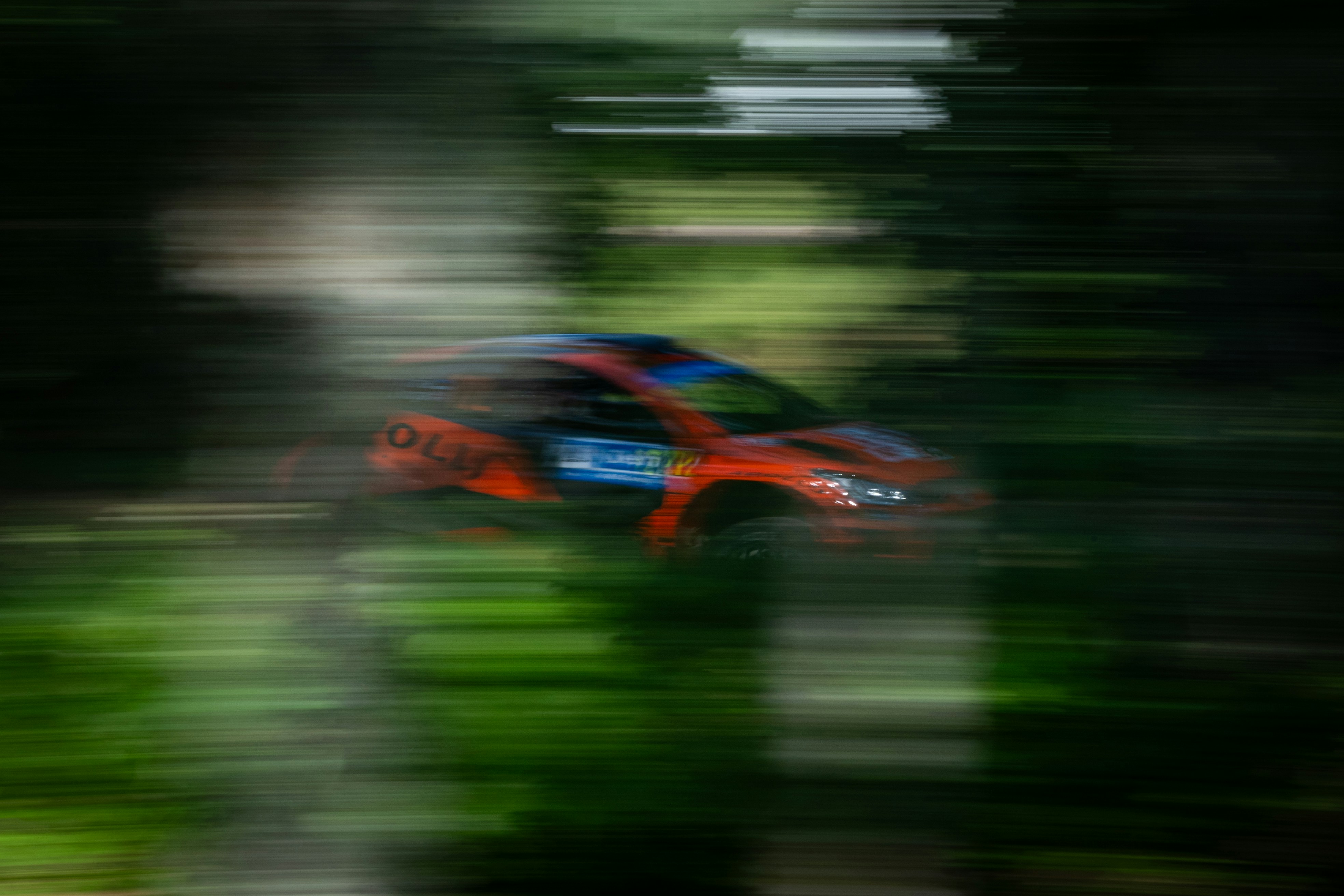 A blurry photo of a car driving down a road