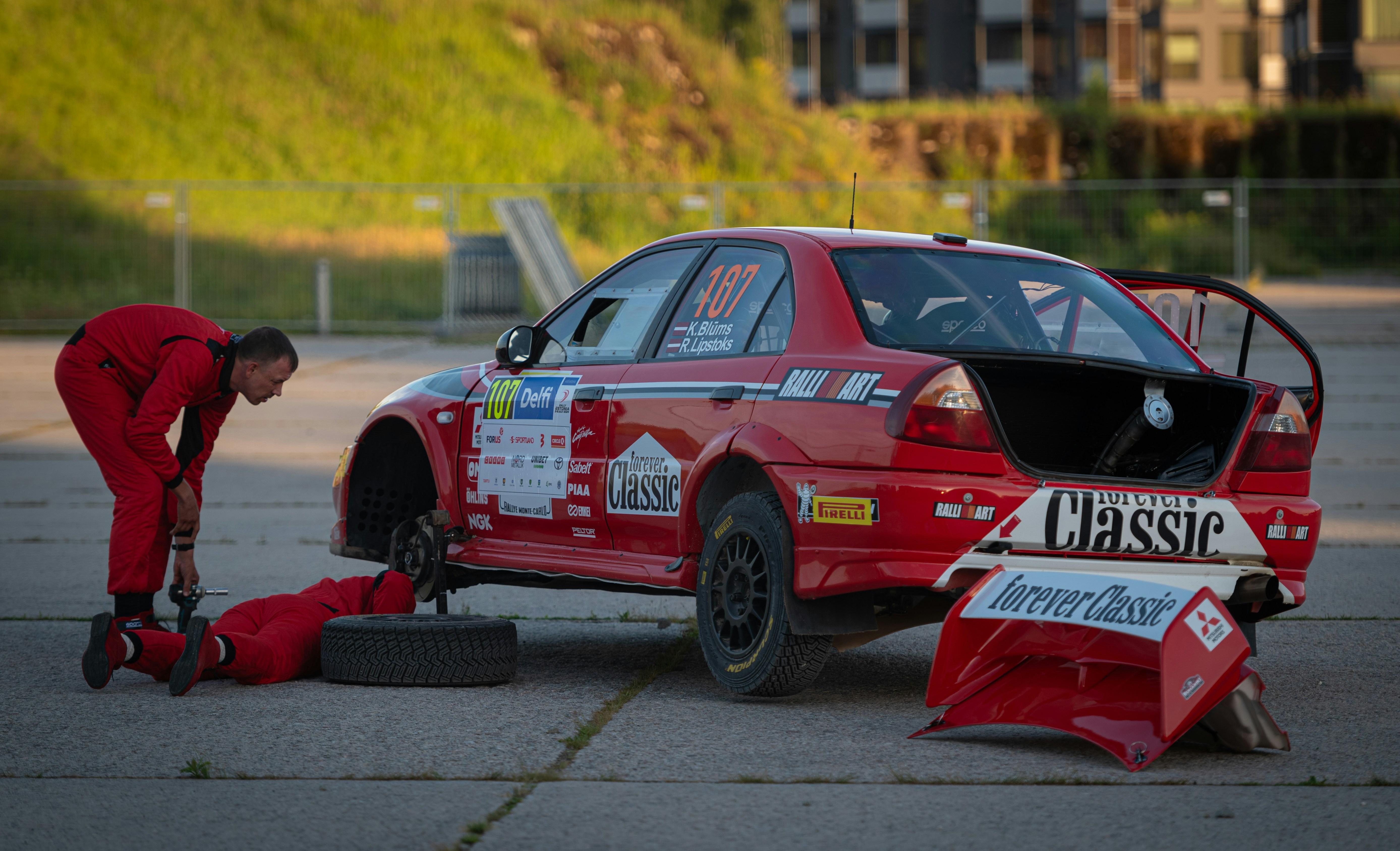 A man working on a car in a parking lot