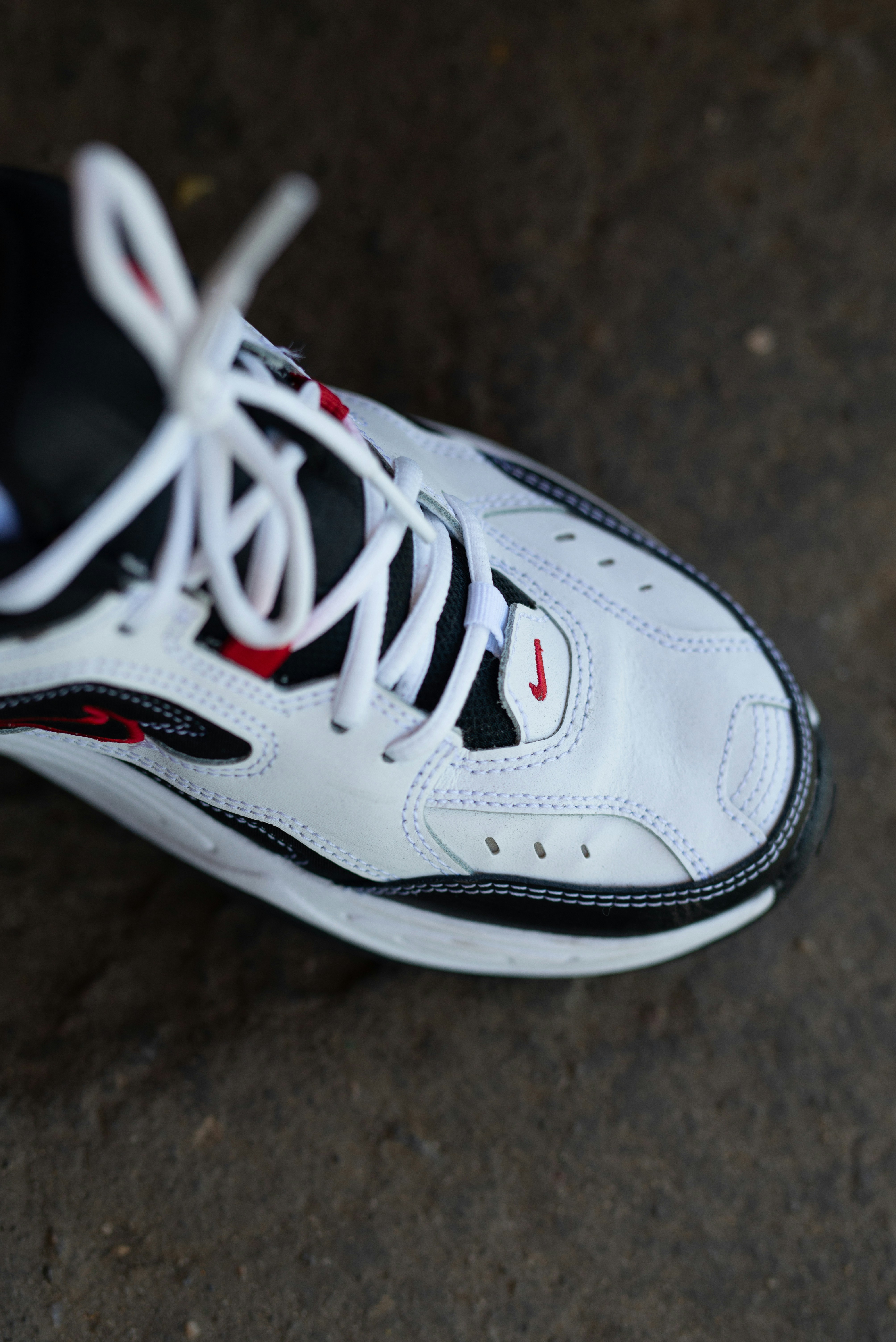 Red Nike sneakers on dark background, flash sale product photography